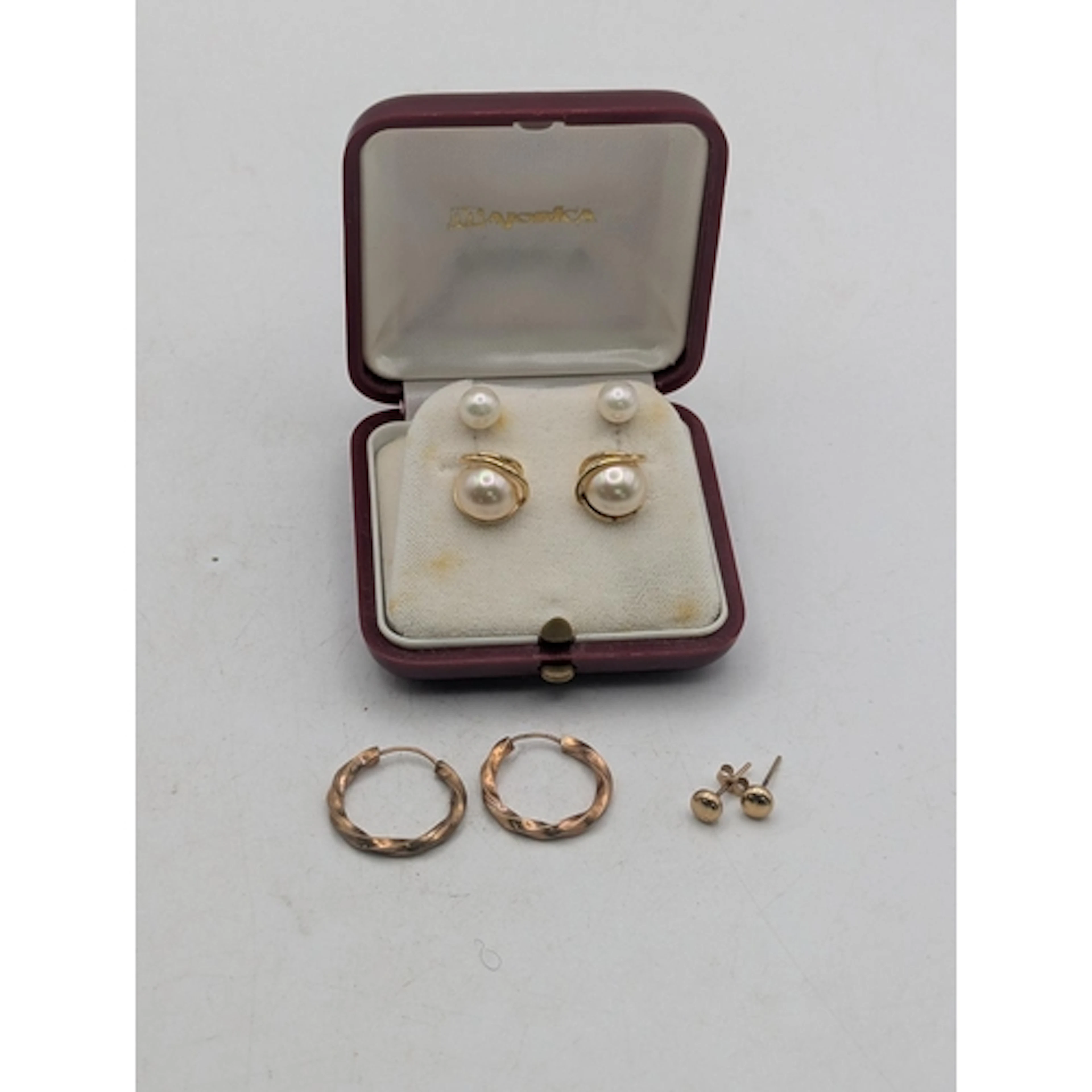 A group of 9ct gold earrings to include a pair of hoop earri...