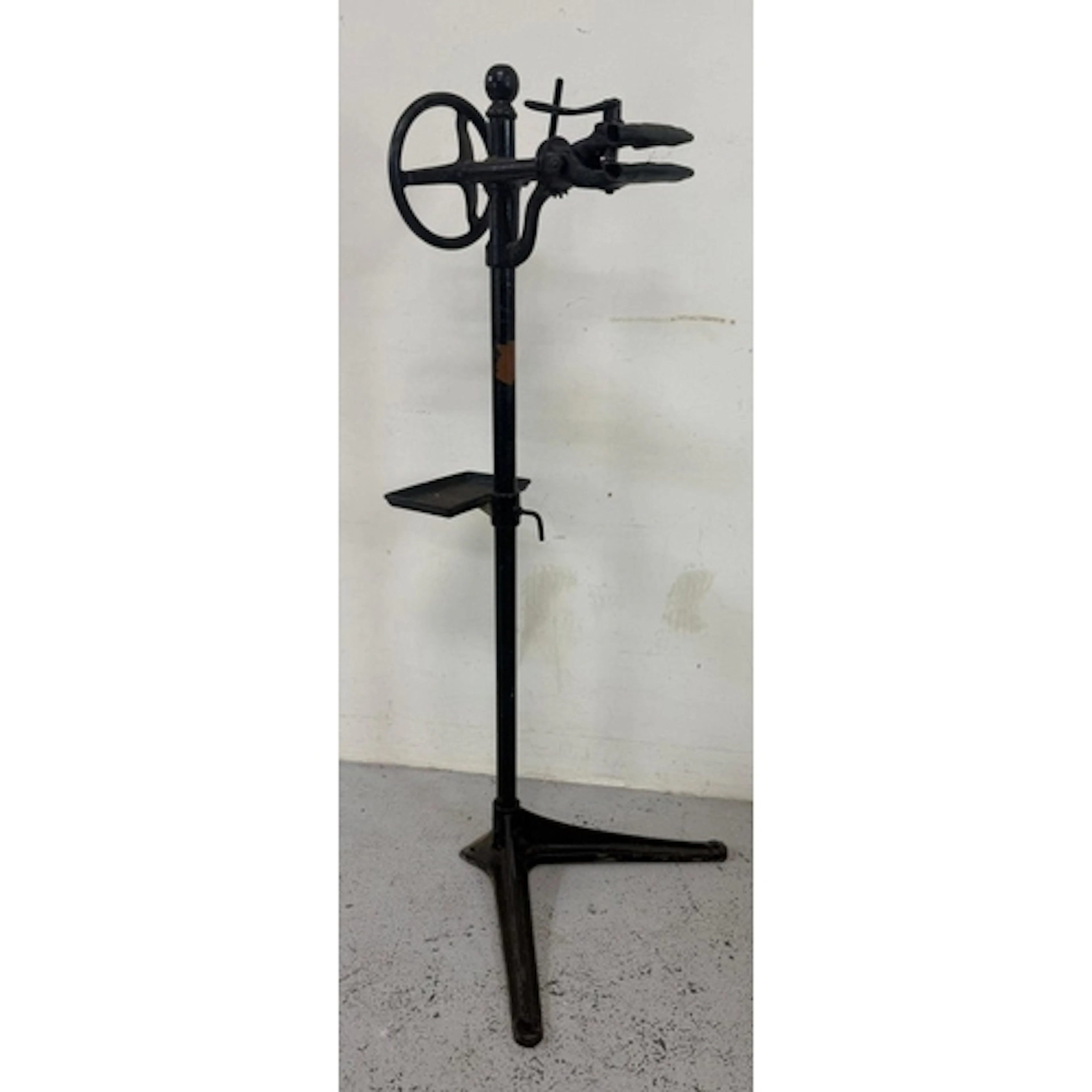 A vintage black cast iron bicycle repair stand.