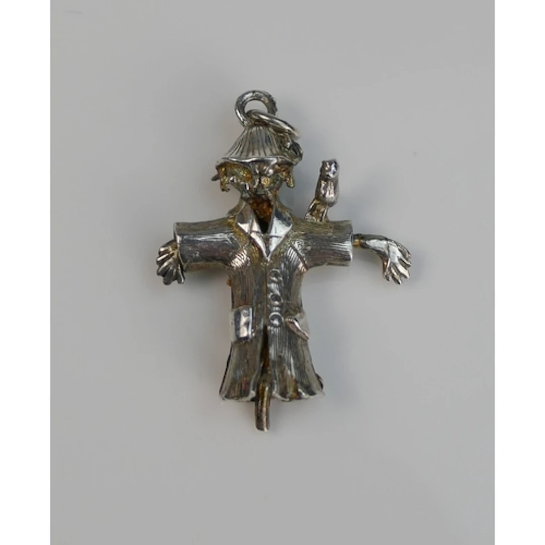 A precious white metal scarecrow pendant with articulated ar...