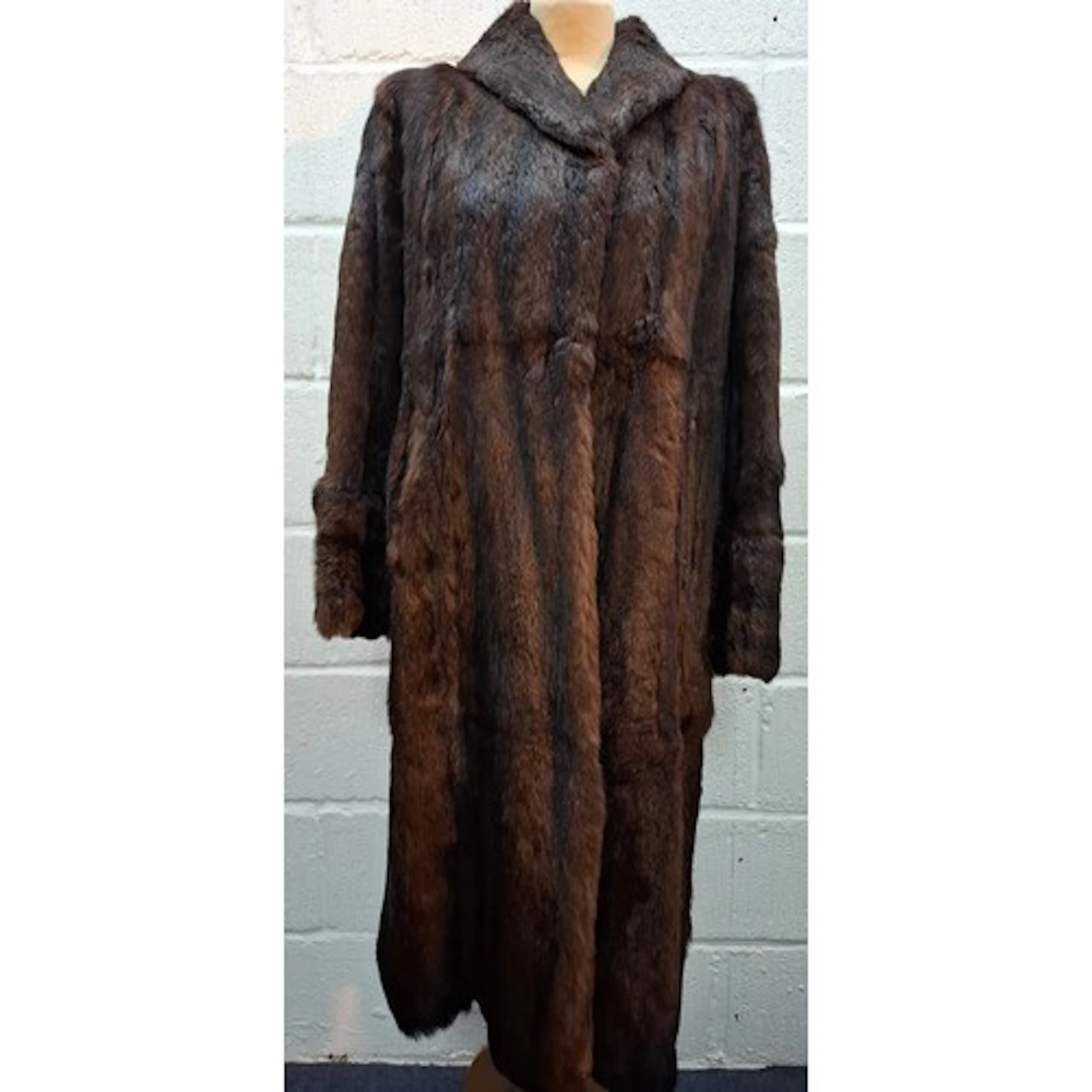 A late 1970's sable fur coat having side pockets and deep cu...