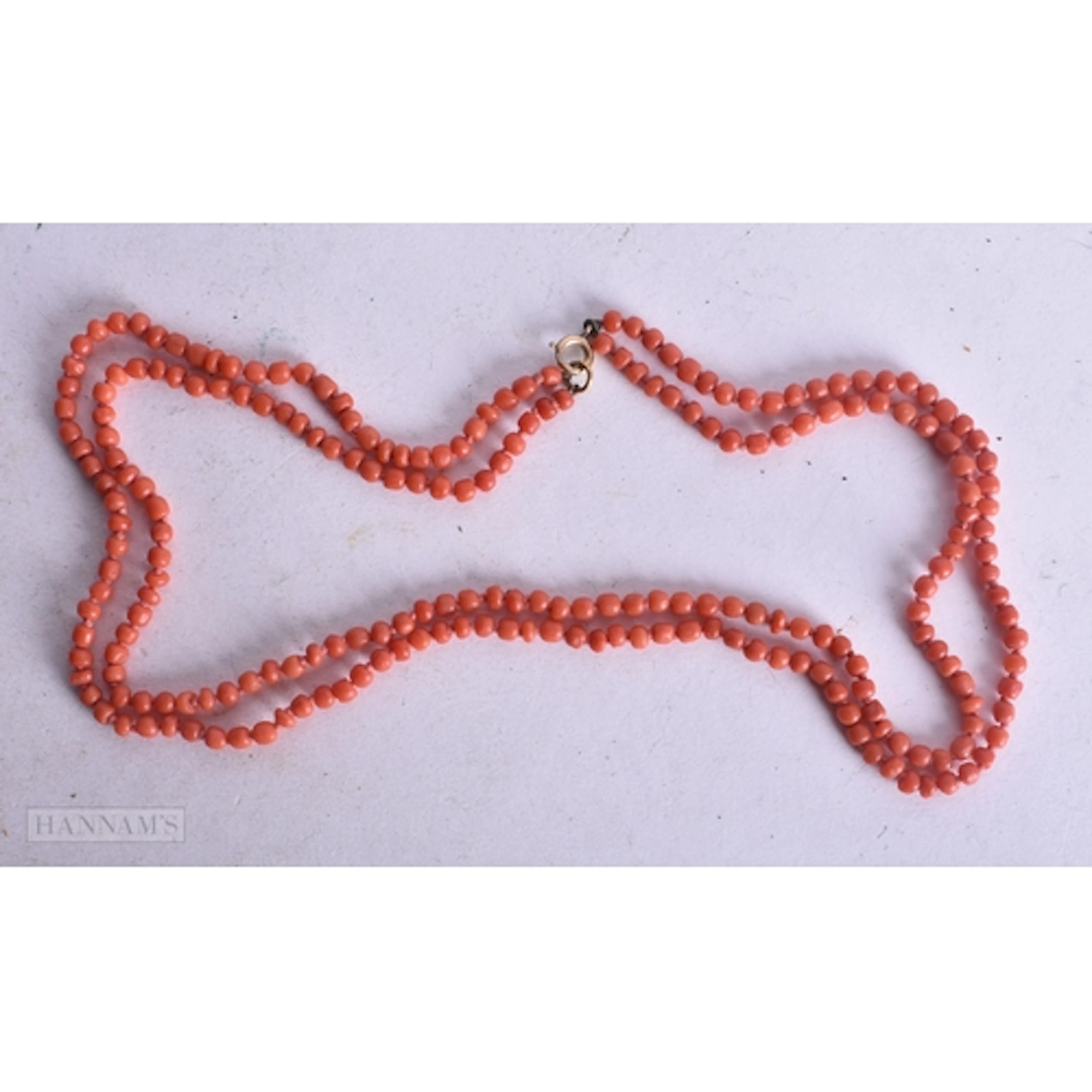A 9CT GOLD CORAL NECKLACE. 20 grams. 86 cm long.