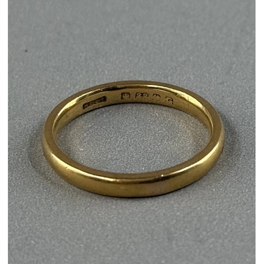 Jewellery: a 22ct yellow gold wedding band, Birmingham 1931,...