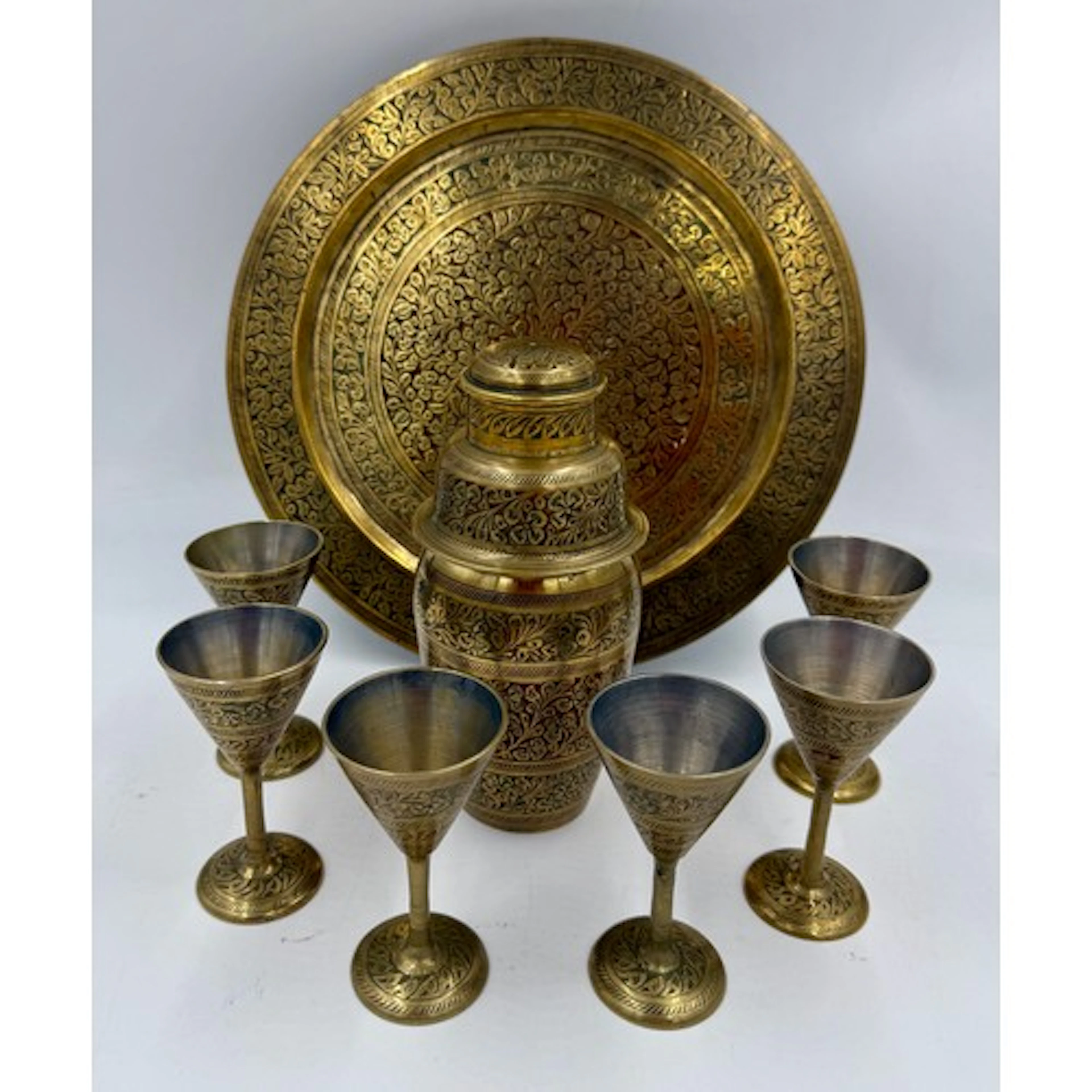 An Indian etched and coloured brass cocktail set to include ...