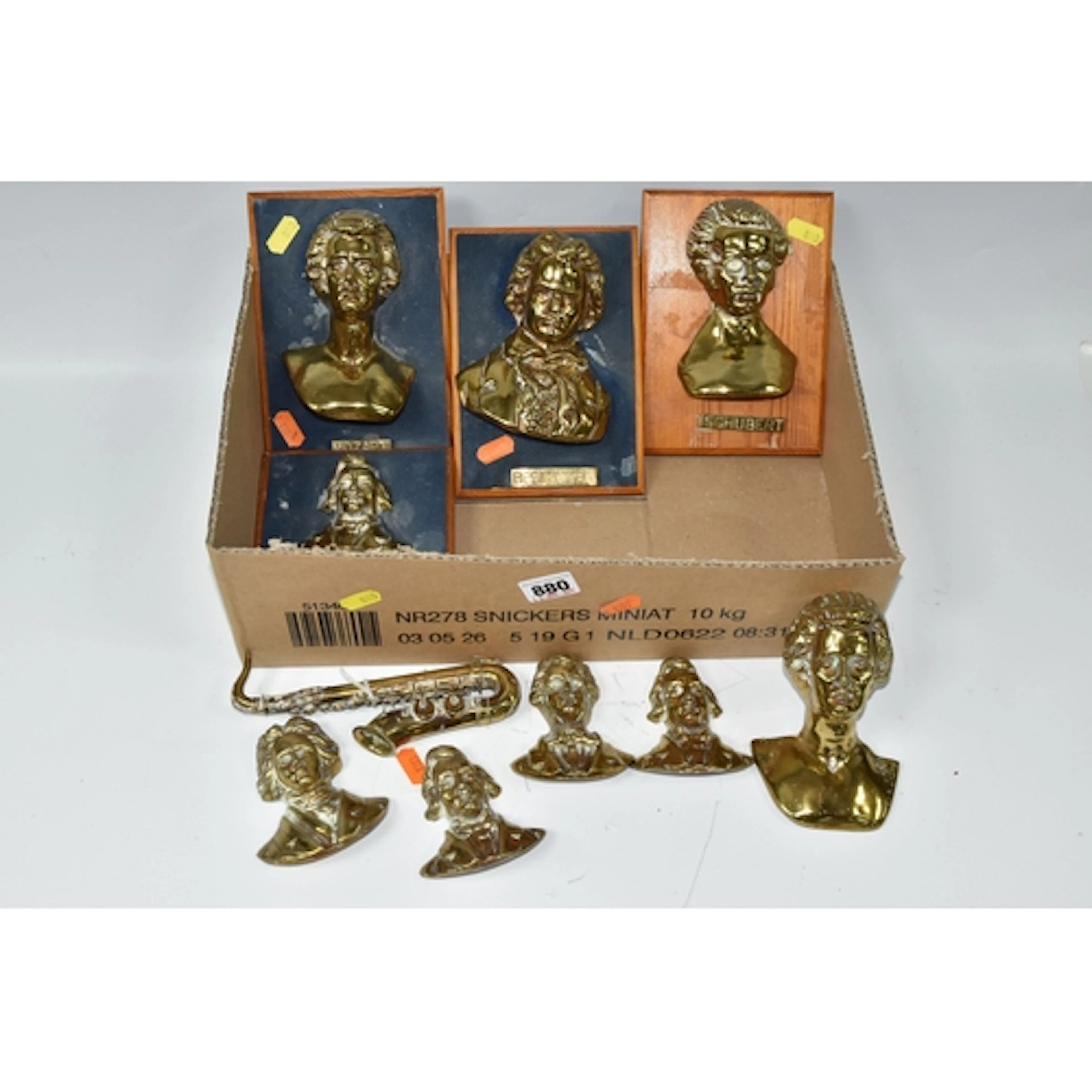 A BOX CONTAINING NINE SOLID BRASS BUSTS OF FAMOUS COMPOSERS,...