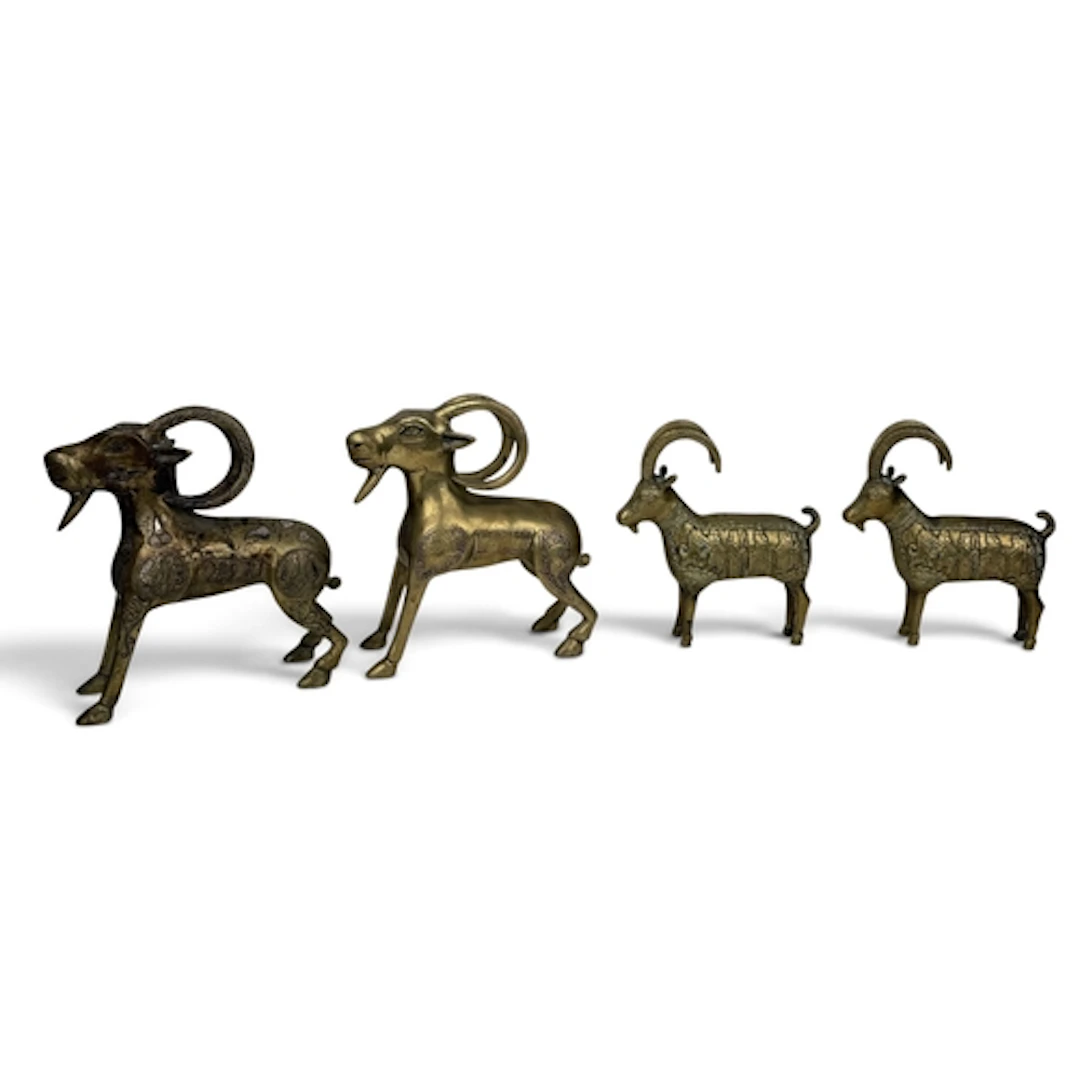 FOUR ISLAMIC BRONZE RAMS One inlaid with silver. Largest 21c...