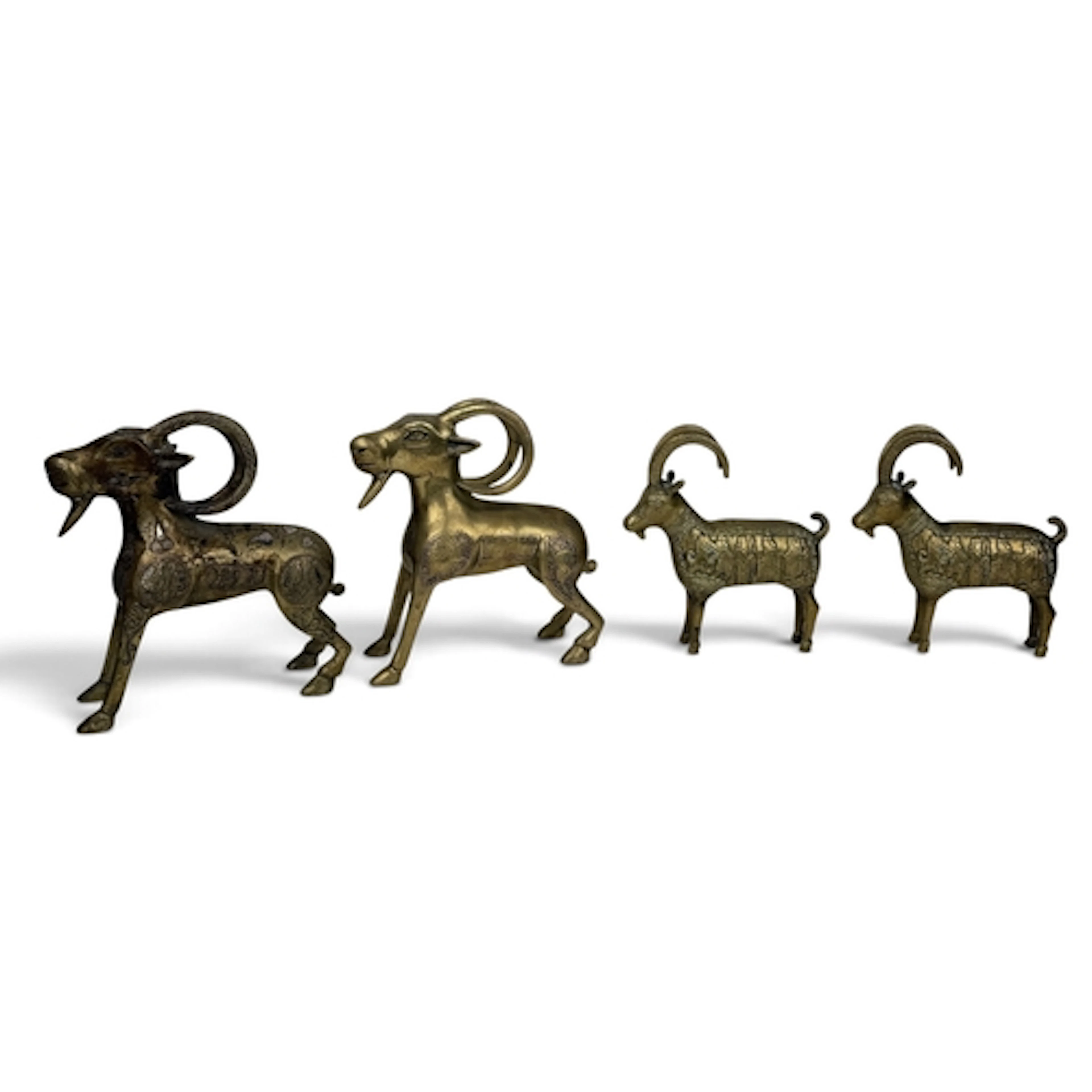 FOUR ISLAMIC BRONZE RAMS One inlaid with silver. Largest 21c...