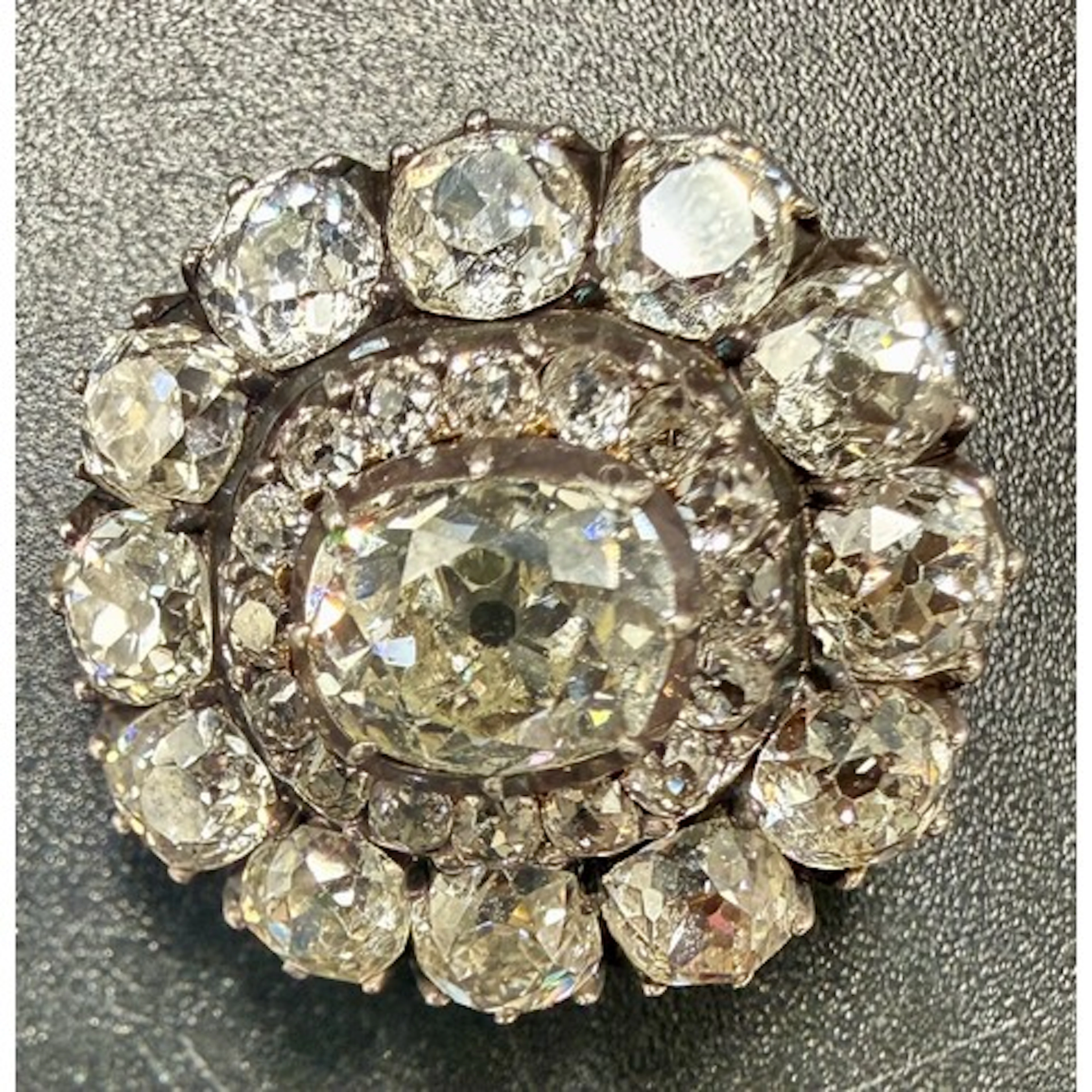 A diamond brooch made up of natural cushion old cut diamonds...