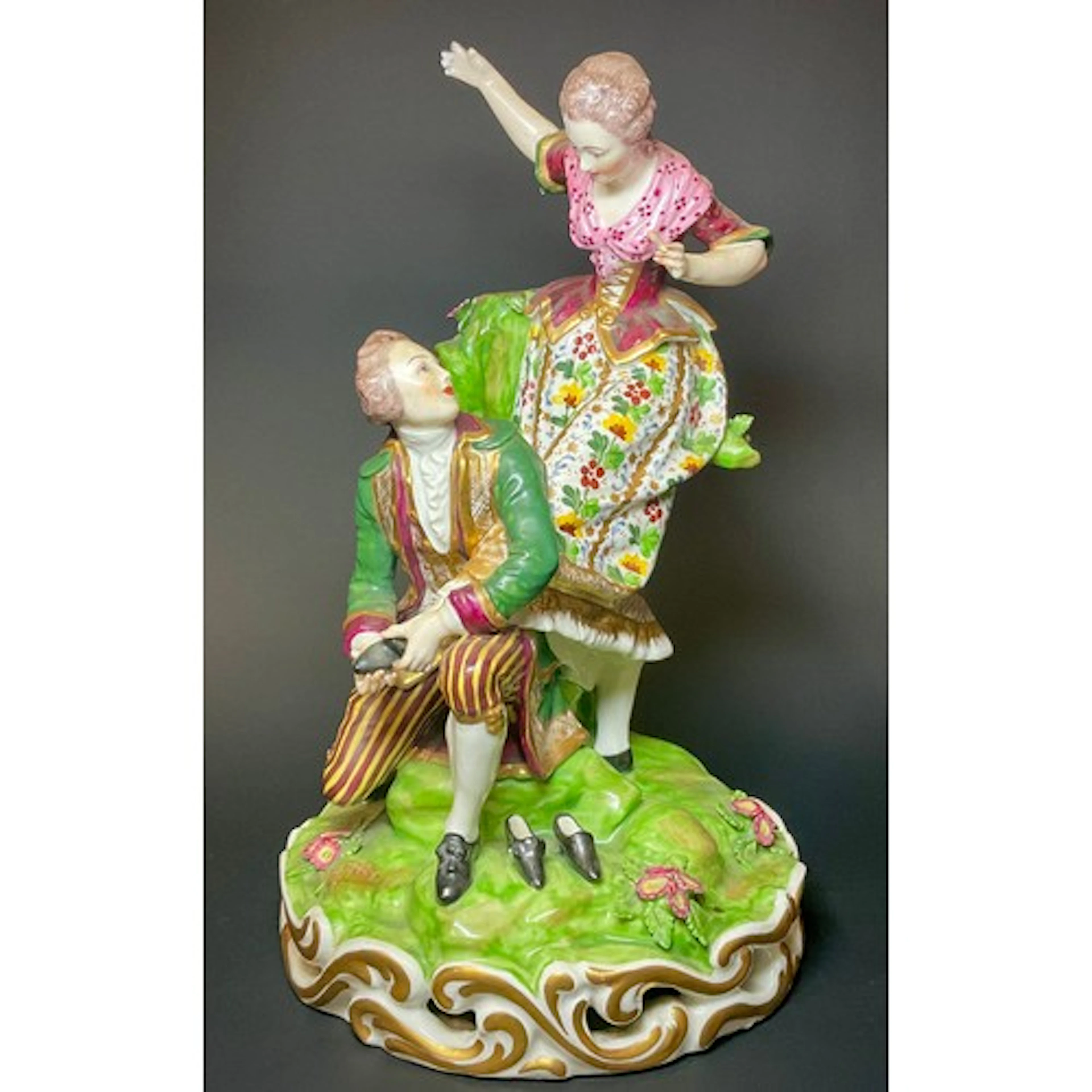 A Derby figure group, Shoe-Maker, modelled with a gallant kn...