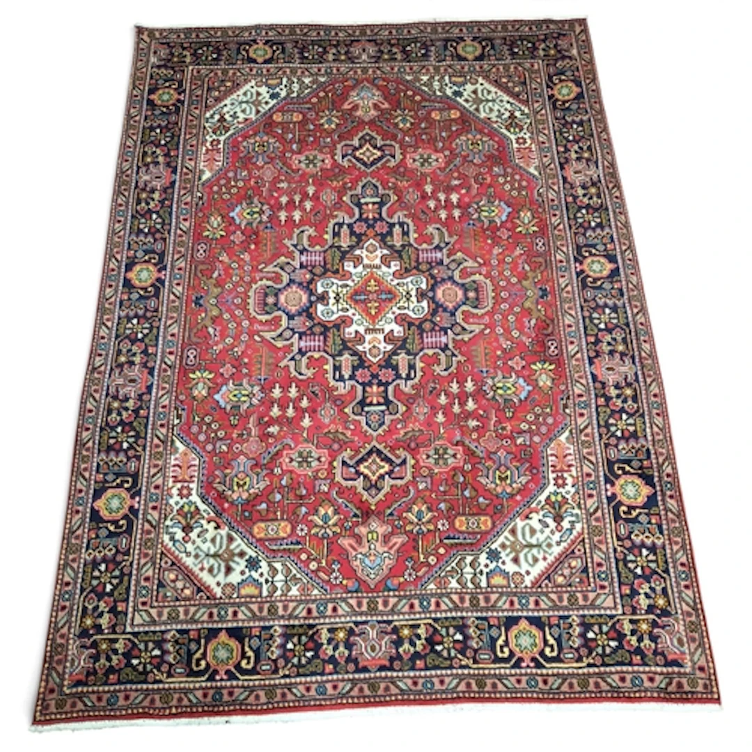 A full wool pile hand woven Persian Tabriz Carpet with a tra...