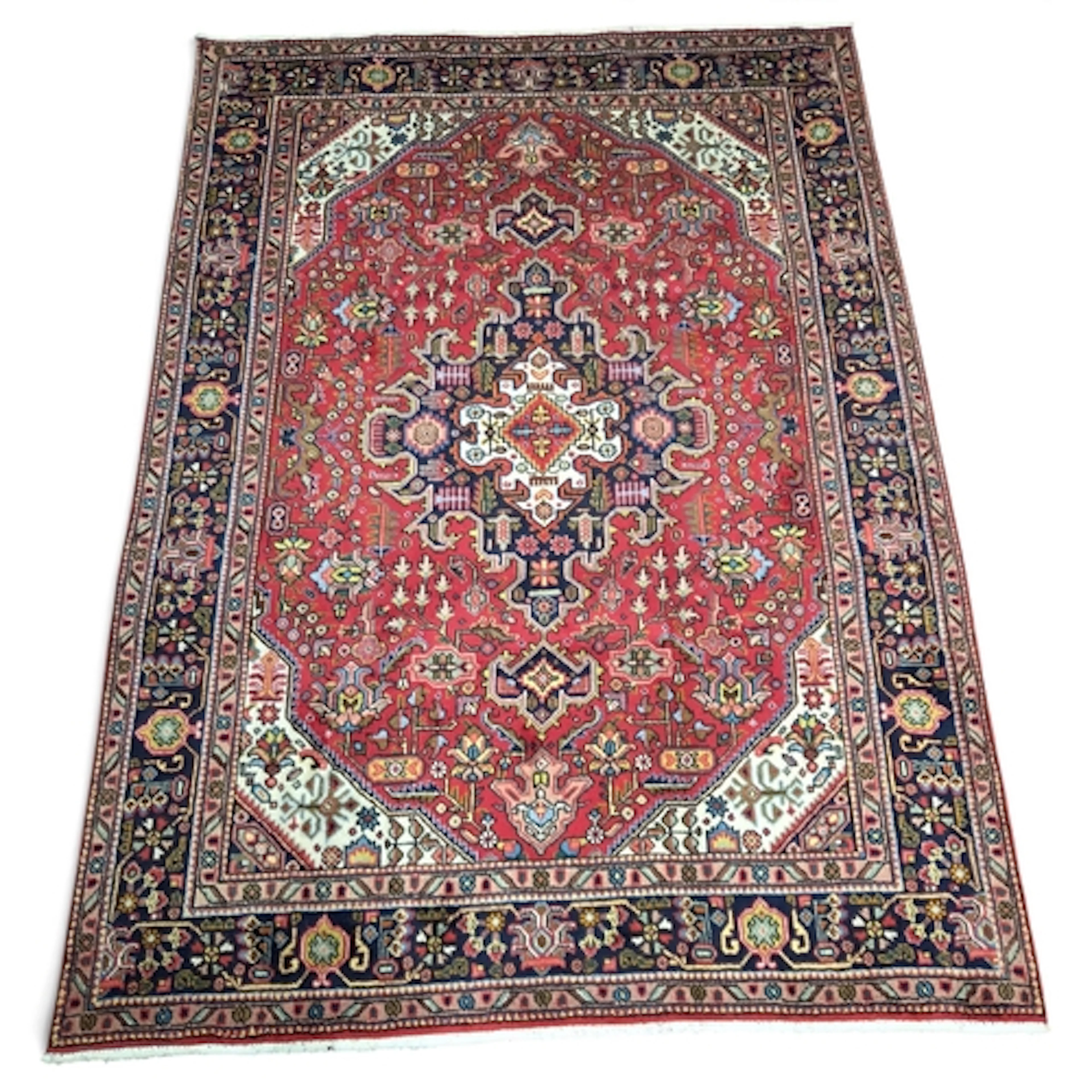 A full wool pile hand woven Persian Tabriz Carpet with a tra...