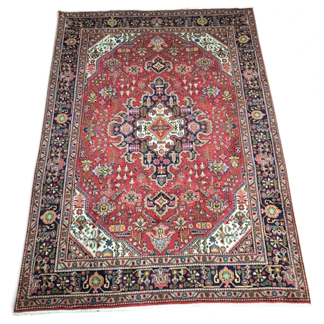 A full wool pile hand woven Persian Tabriz Carpet with a tra...