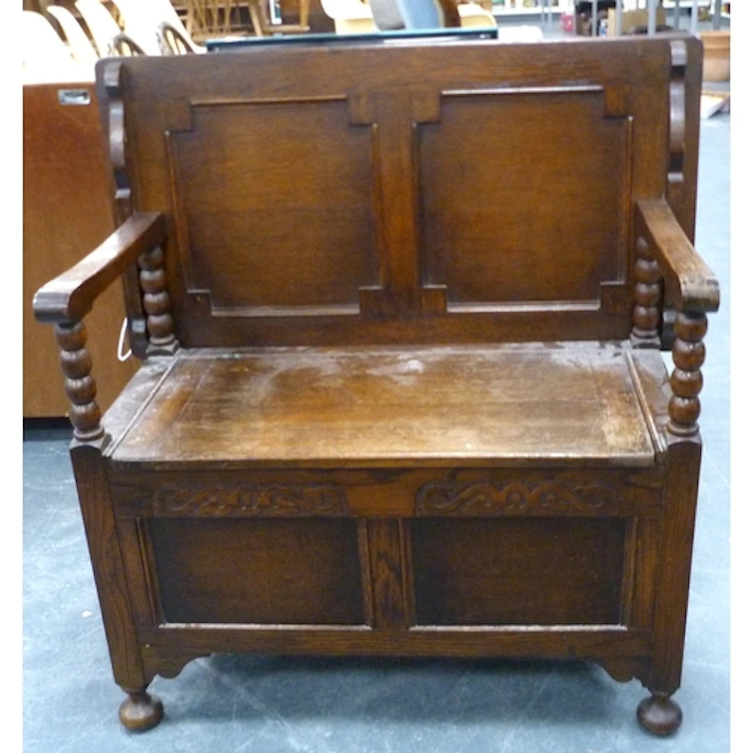 Carved oak monks bench with hinged back.