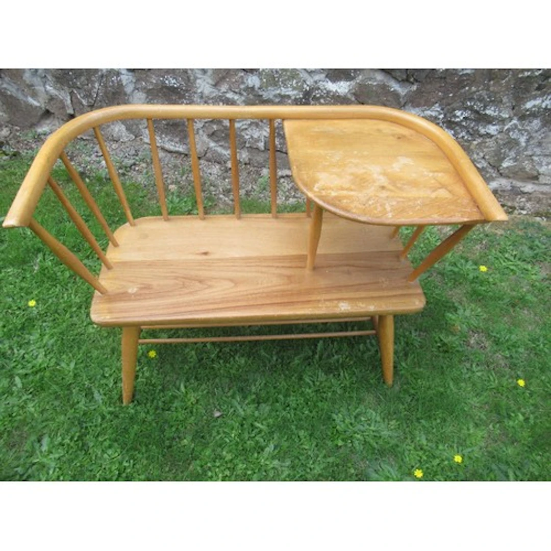 An ercol style midcentury telephone seat with label for Chip...
