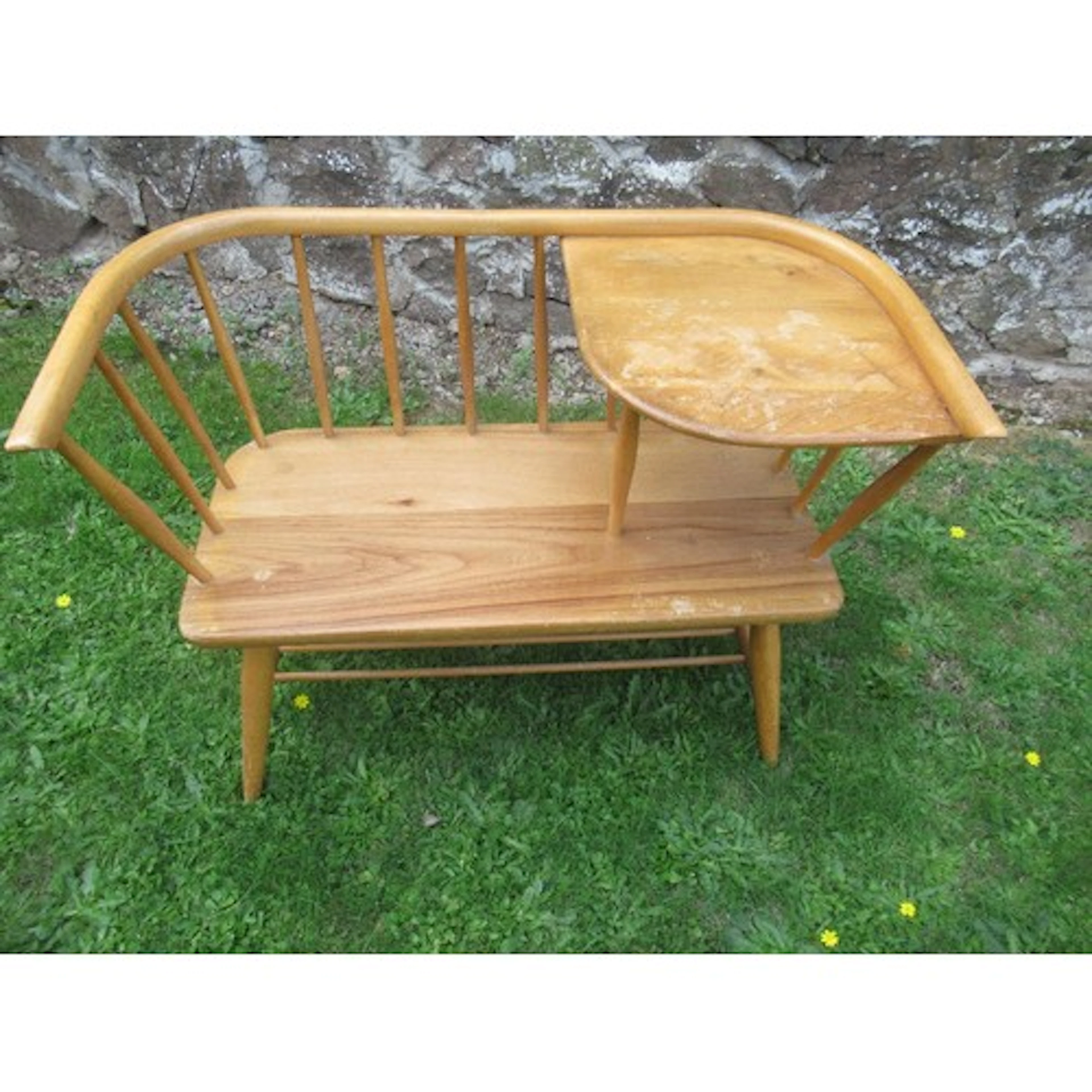 An ercol style midcentury telephone seat with label for Chip...