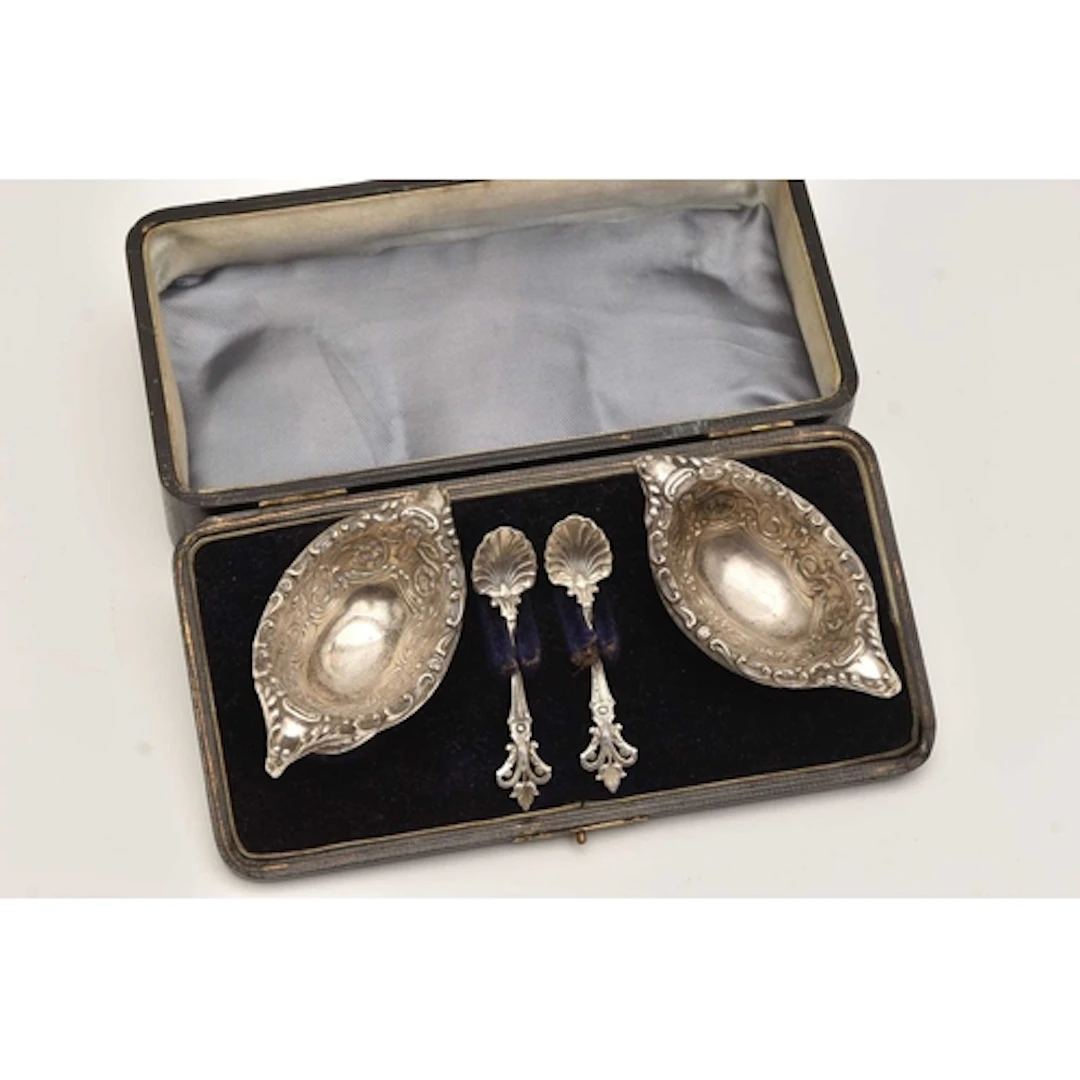 A CASED PAIR OF LATE VICTORIAN SILVER SALTS, each of an oval...