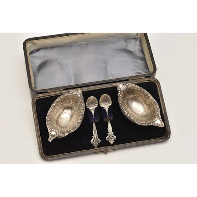 A CASED PAIR OF LATE VICTORIAN SILVER SALTS, each of an oval...
