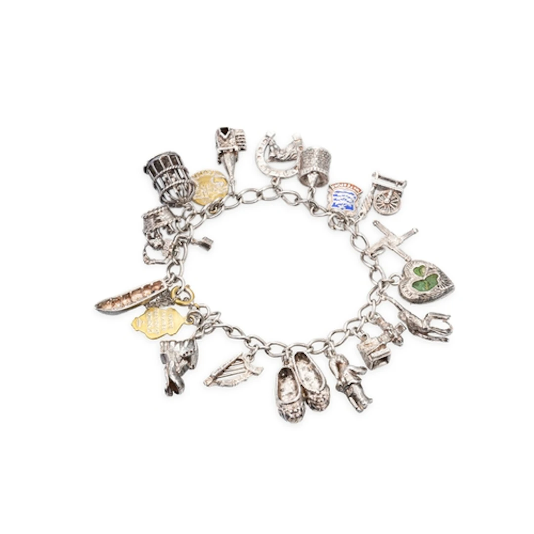A STERLING SILVER CHARM BRACELET, set with various charms, g...