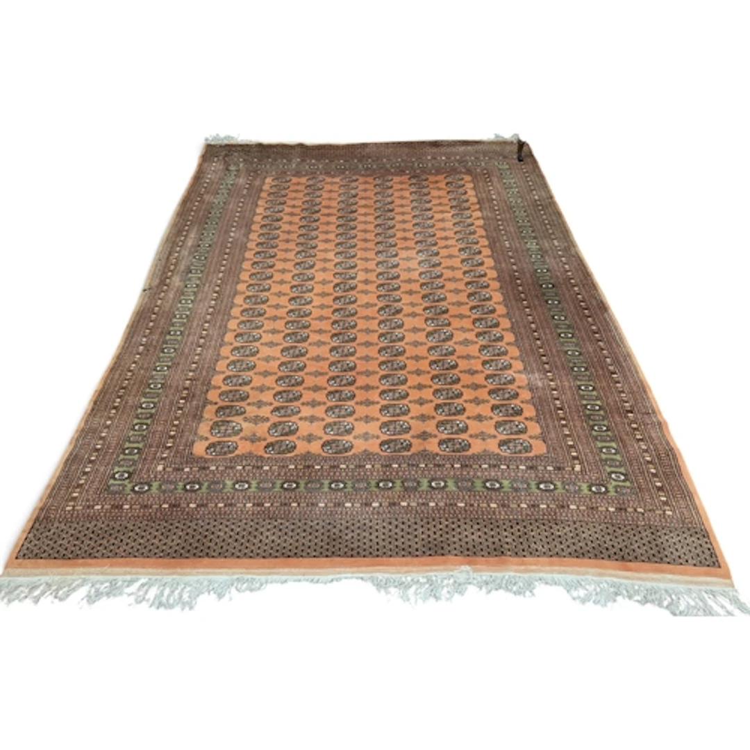 A large Persian Bokhara style Red Rust ground Carpet, with r...