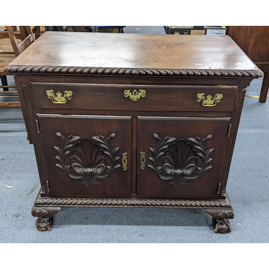 A George V mahogany cabinet having a single drawer above two...