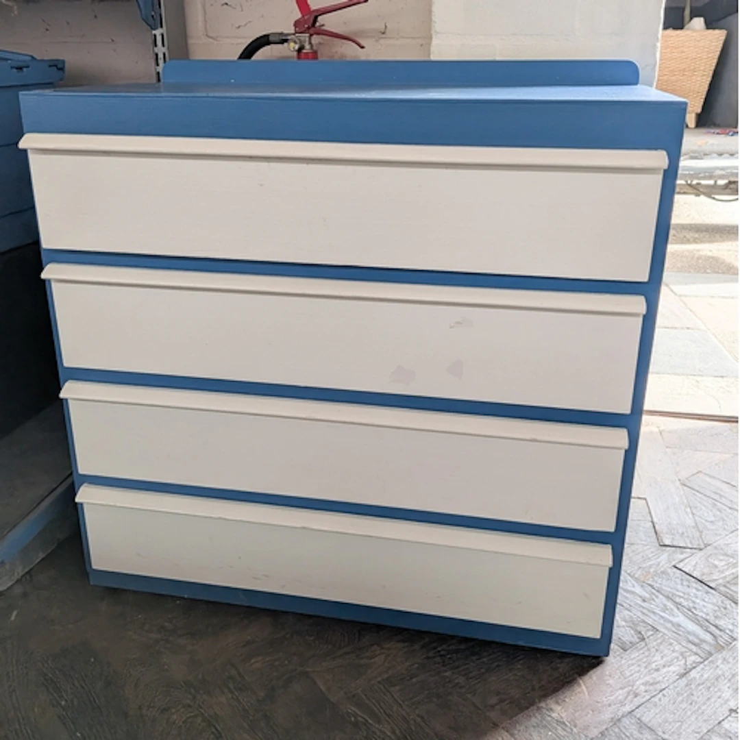 A blue and white painted chest of four long drawers