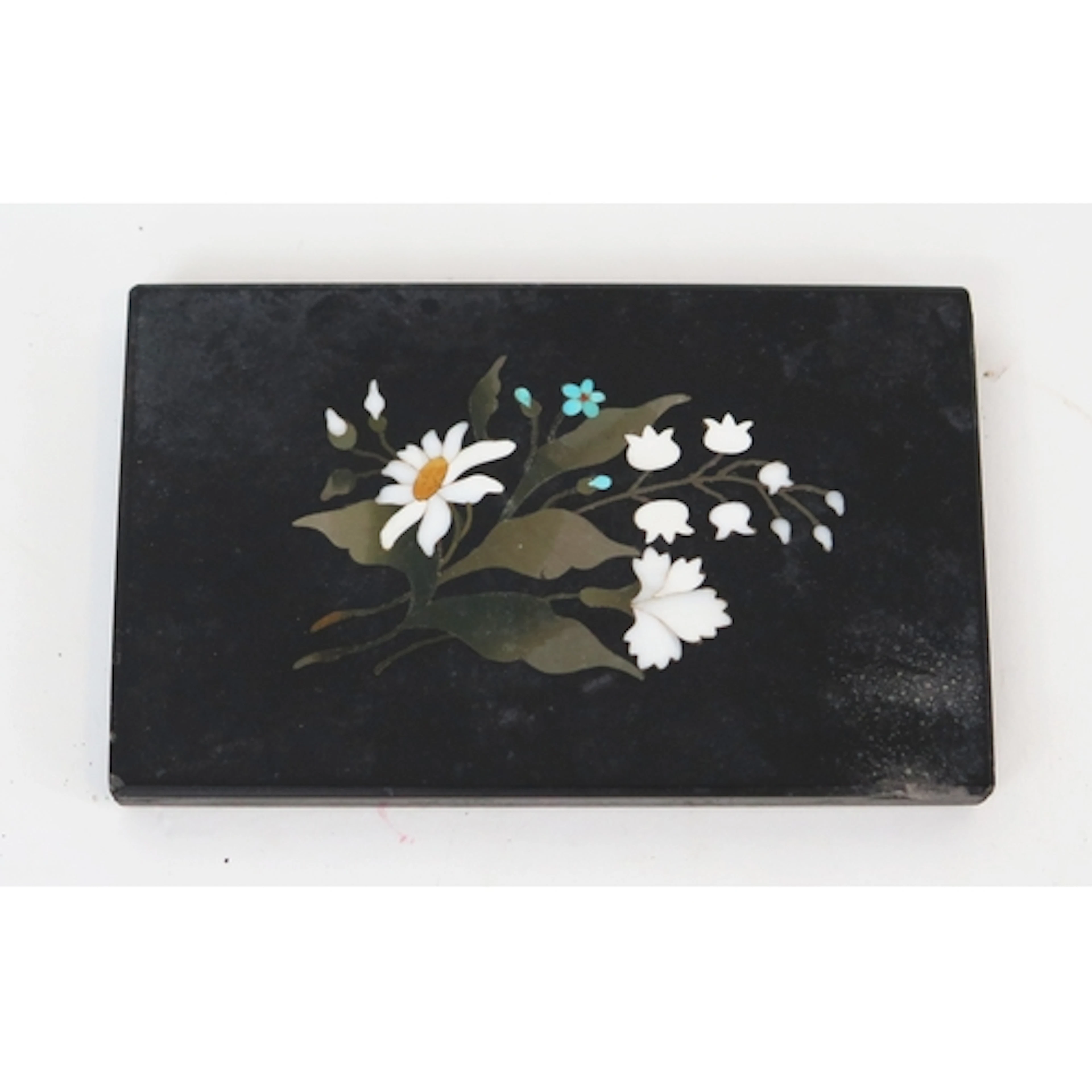 A late 19th century pietra dura black marble paperweight wit...