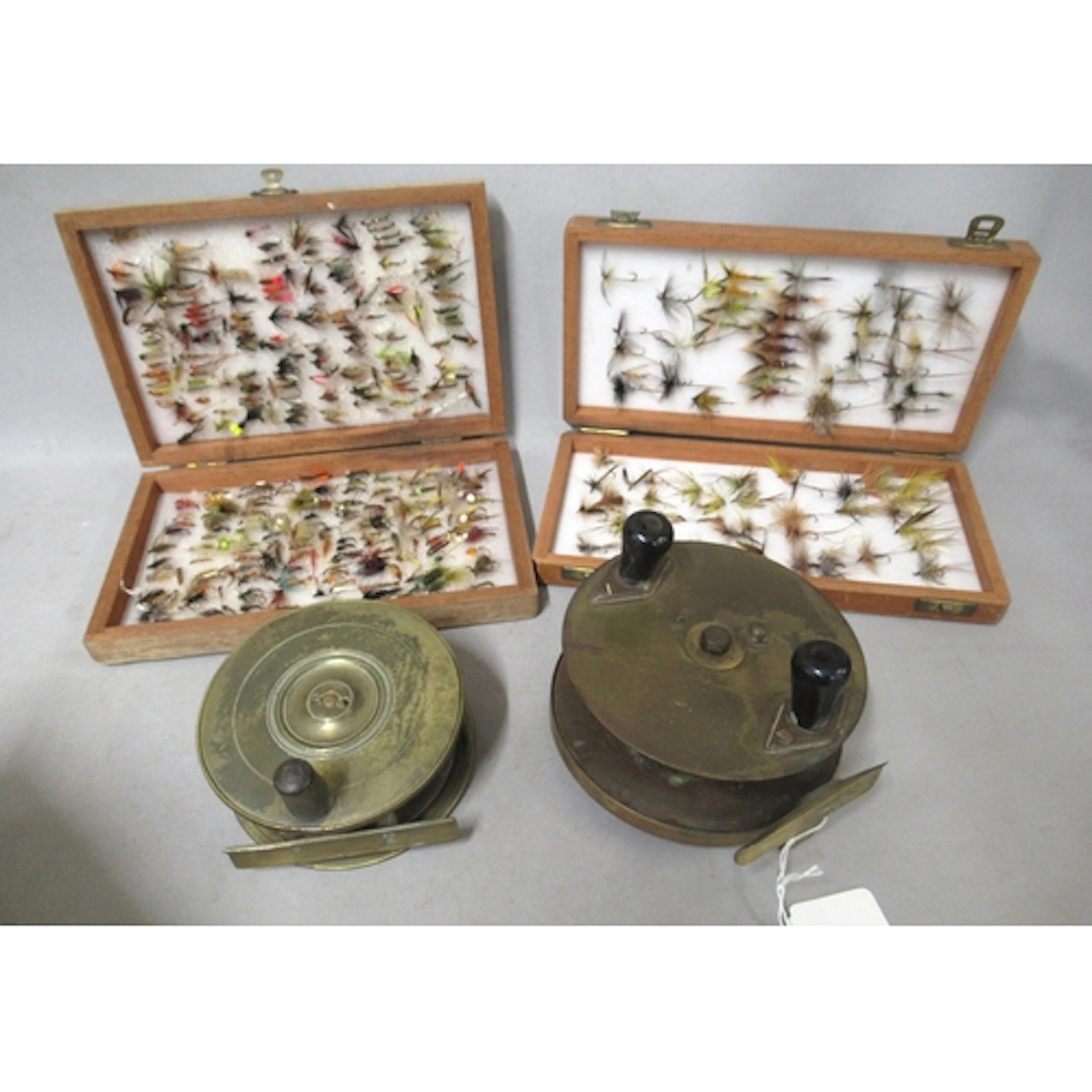 Unmarked brass centre pin reel, 4 1/4" diameter, together wi...