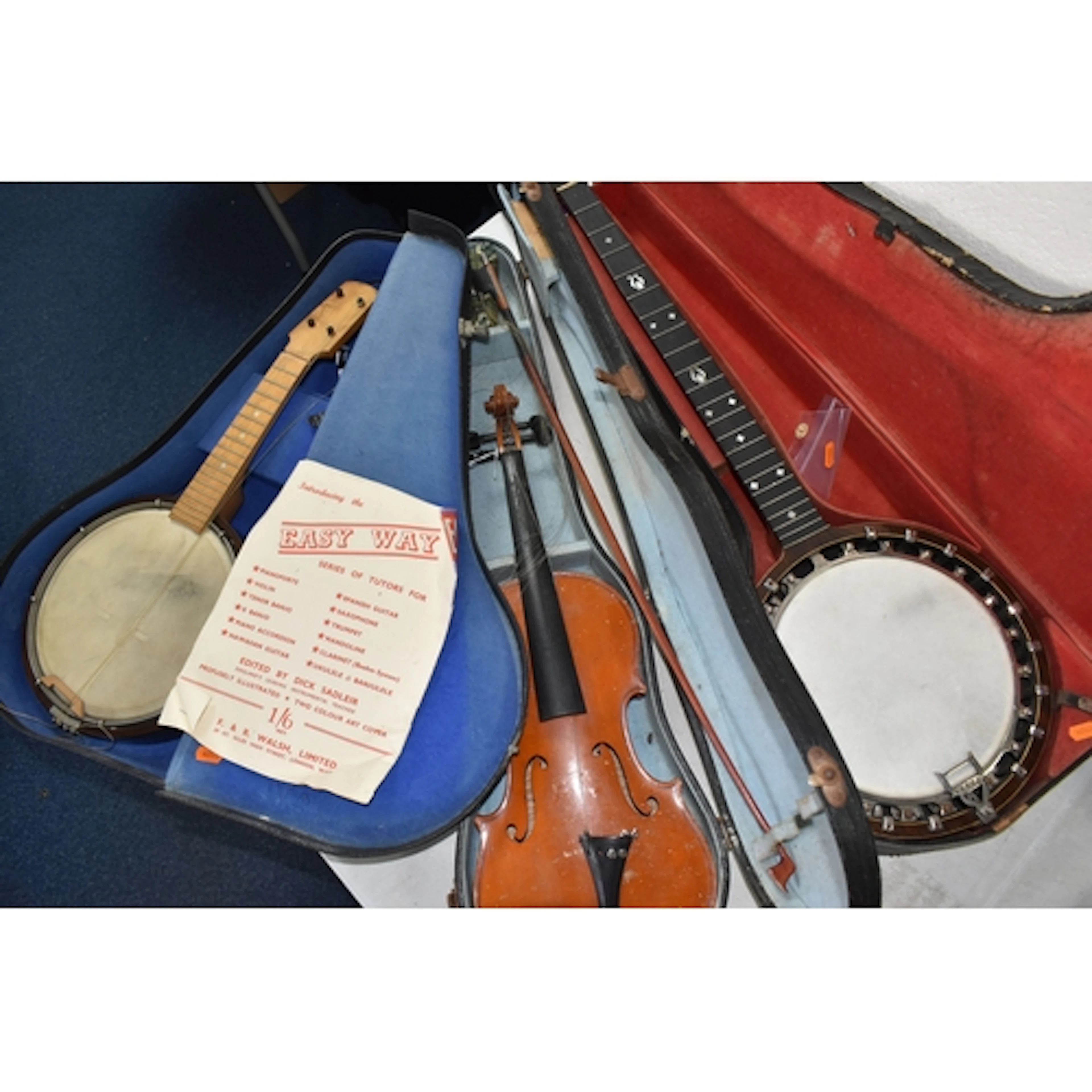 THREE VINTAGE CASED STRINGED INSTRUMENTS comprising a George...