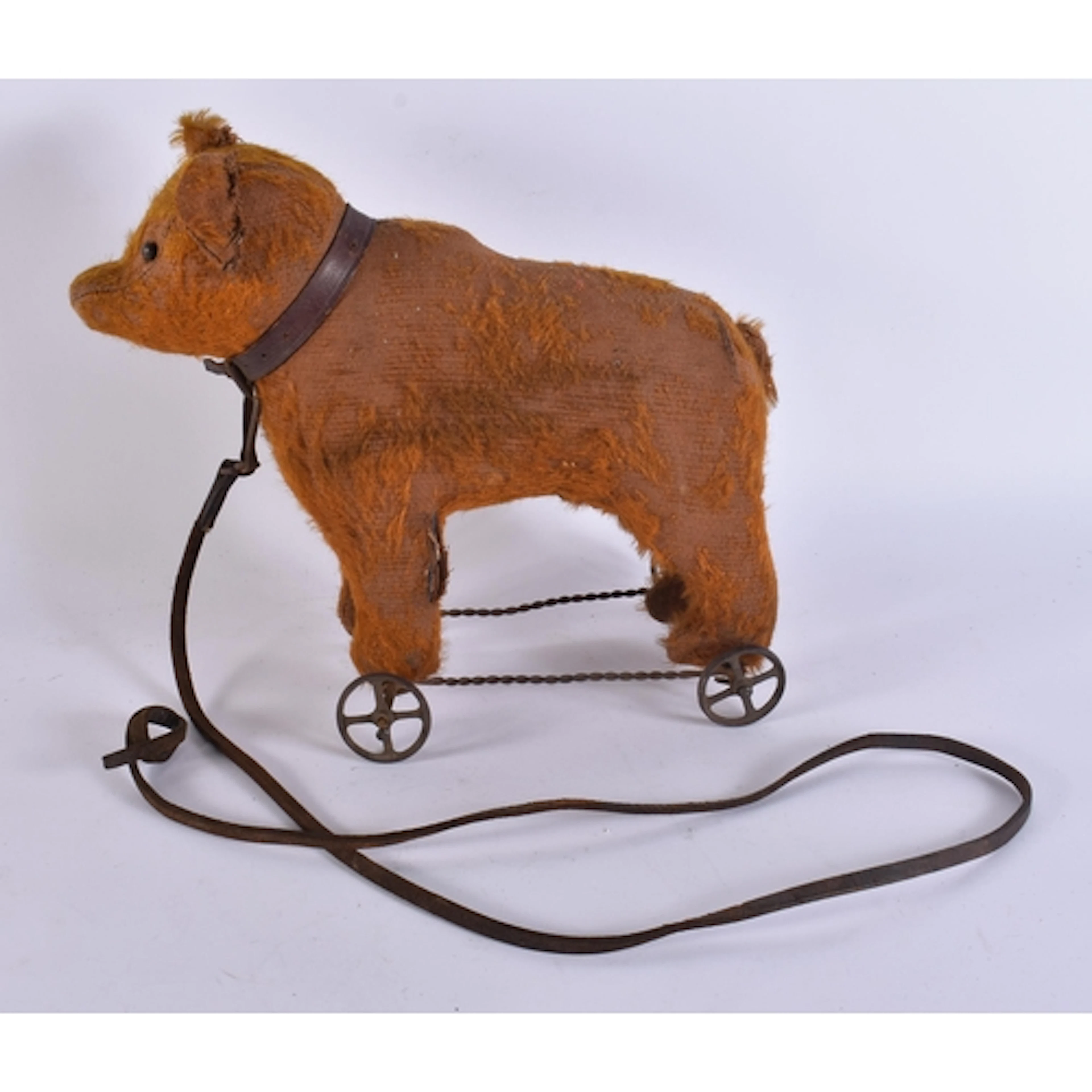 A PULL ALONG BEAR ON WHEELS possibly Steiff. Bear 26 cm x 24...