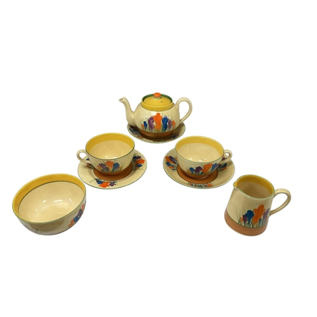 A Clarice Cliff globe shape crocus part tea set comprising a...