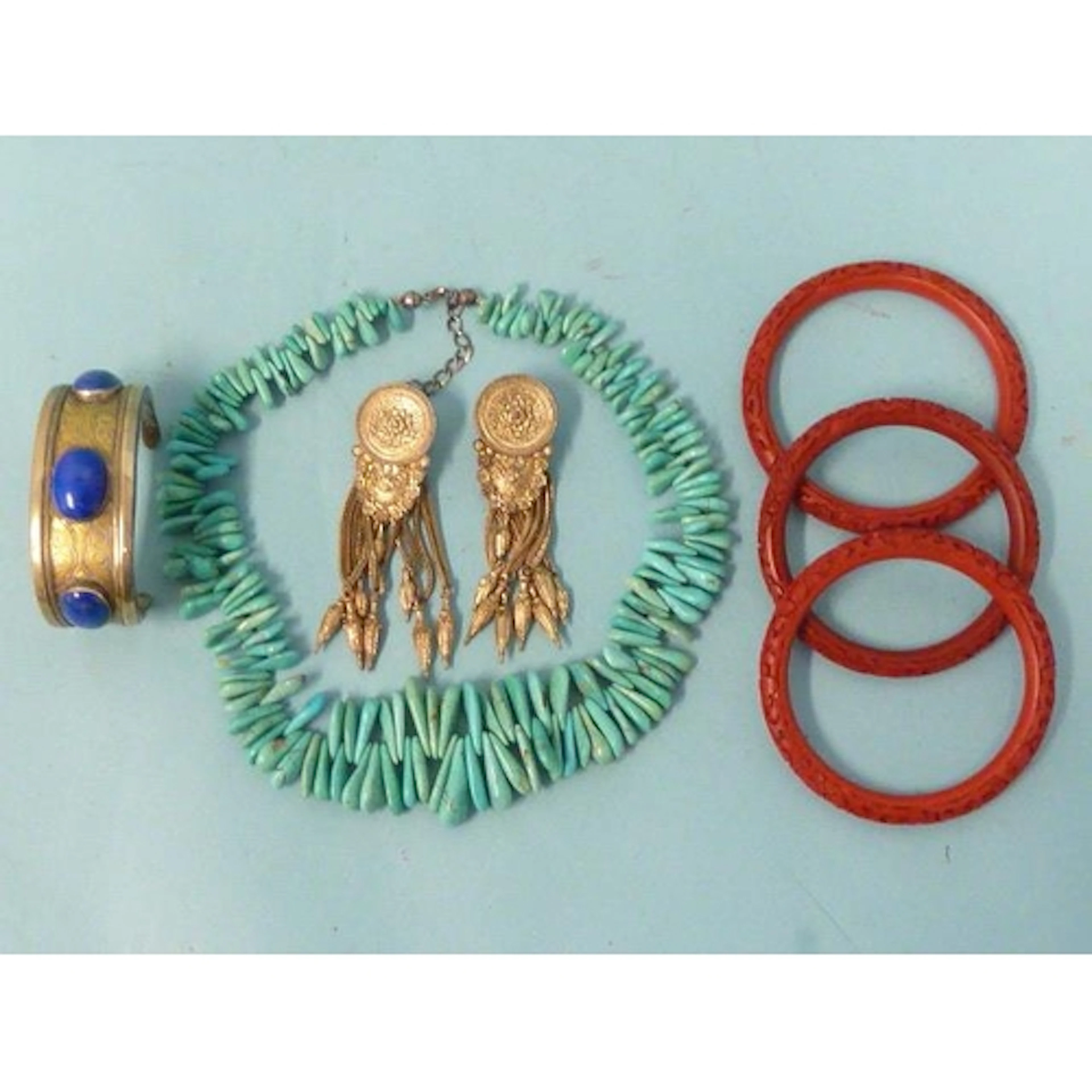 A Turkmeni bangle set three sodalite cabochons, a pair of wh...