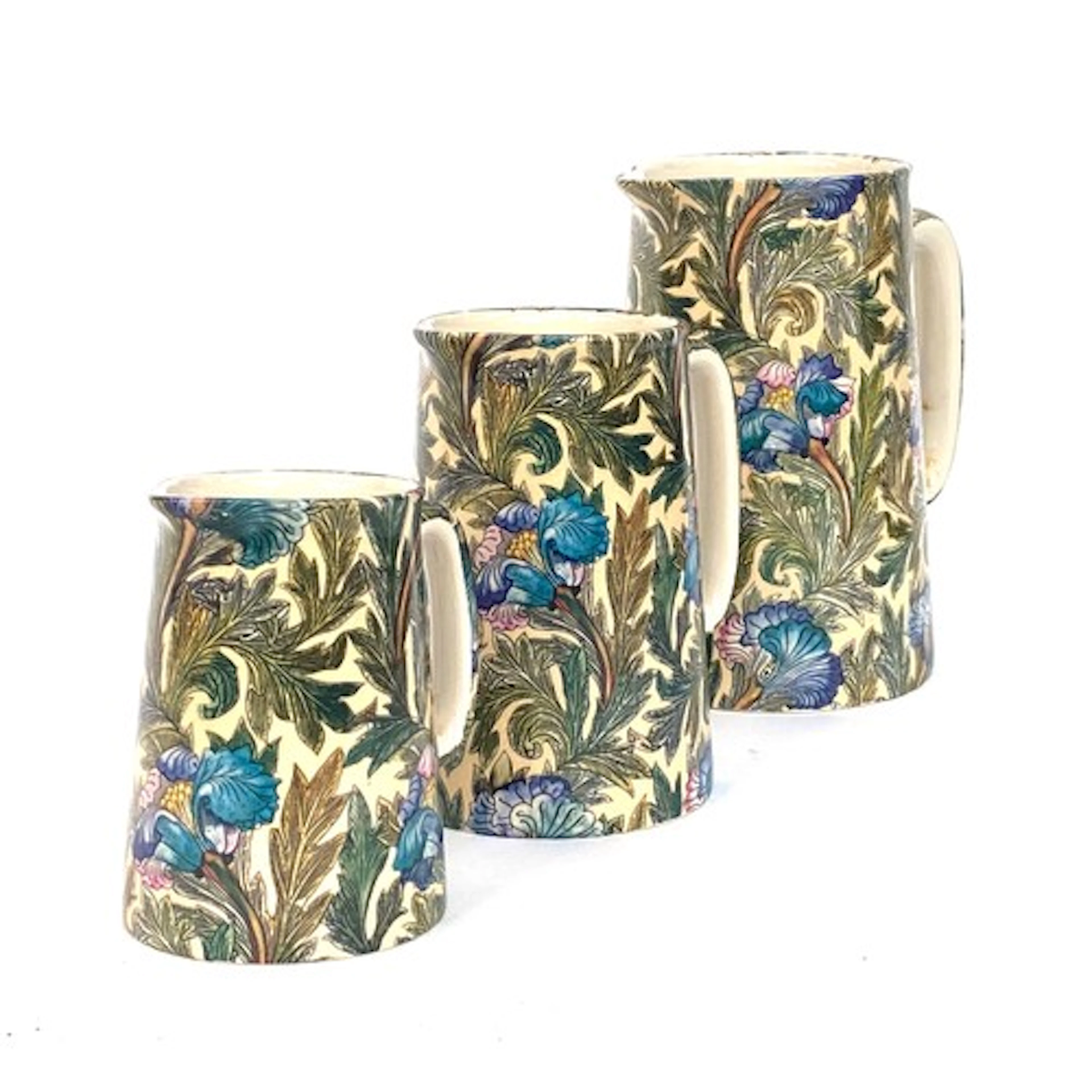 A graduating set of three jugs in a William Morris style pat...