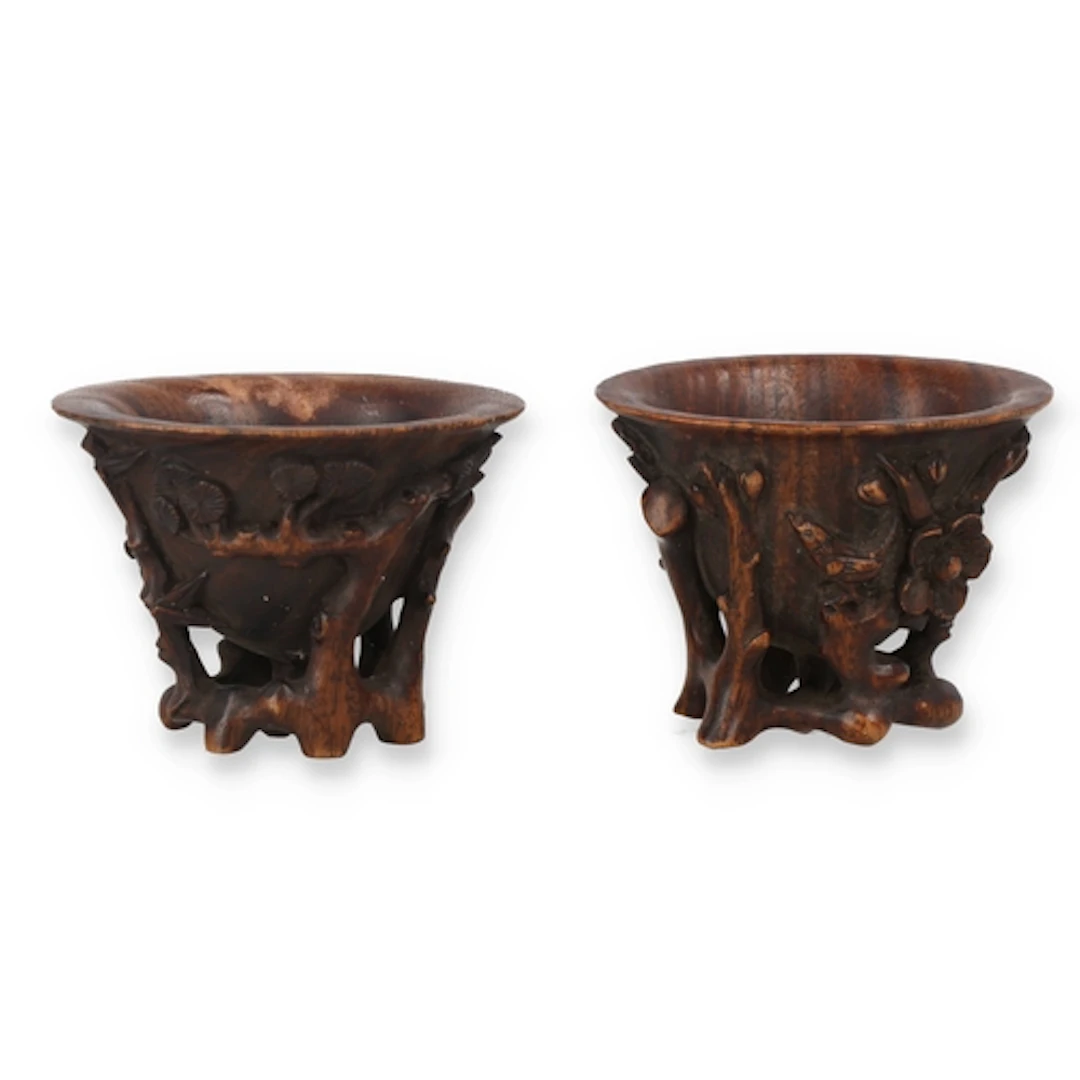 A PAIR OF CARVED WOOD LIBATION CUPS 5.5cm W