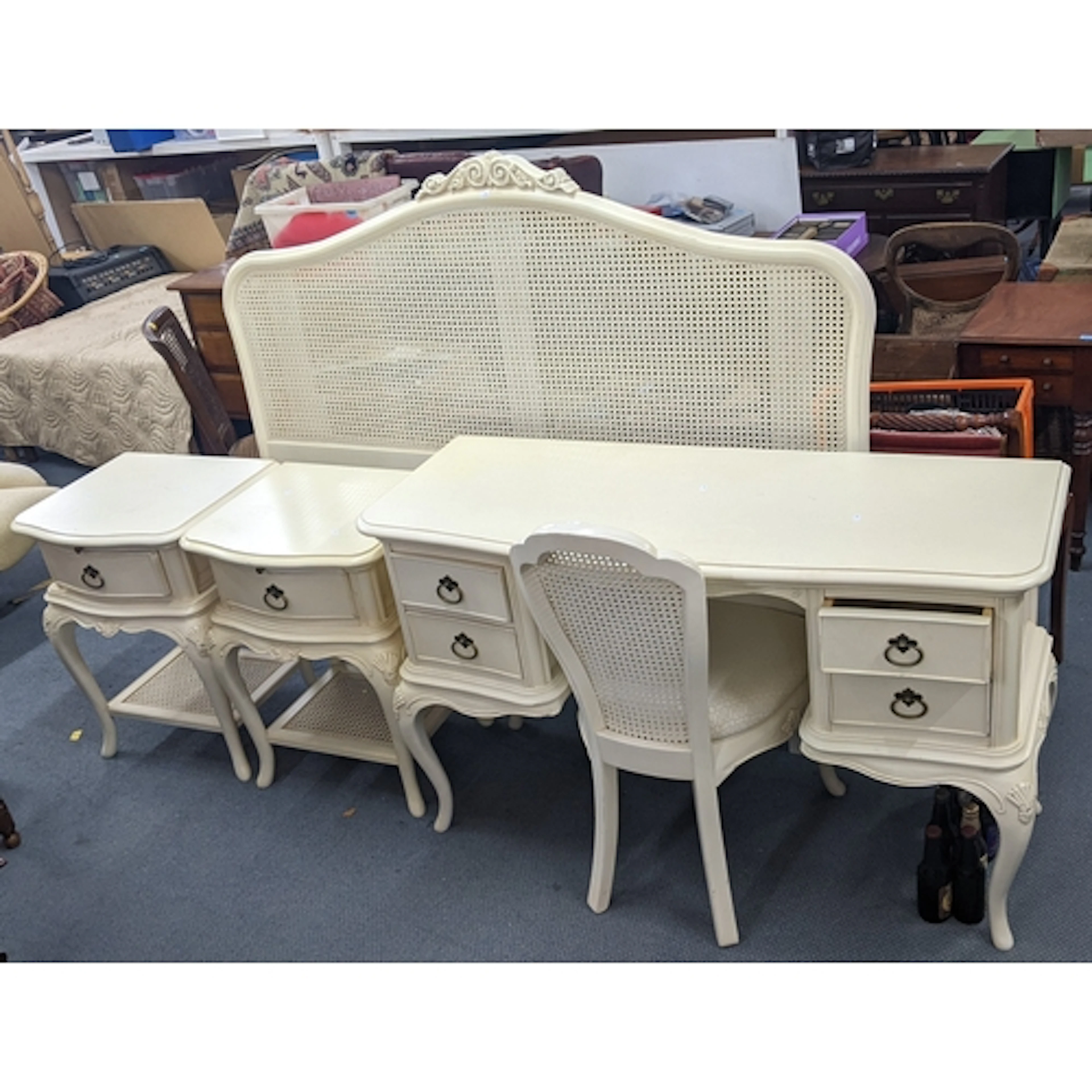 A collection of modern cream painted bedroom furniture to in...