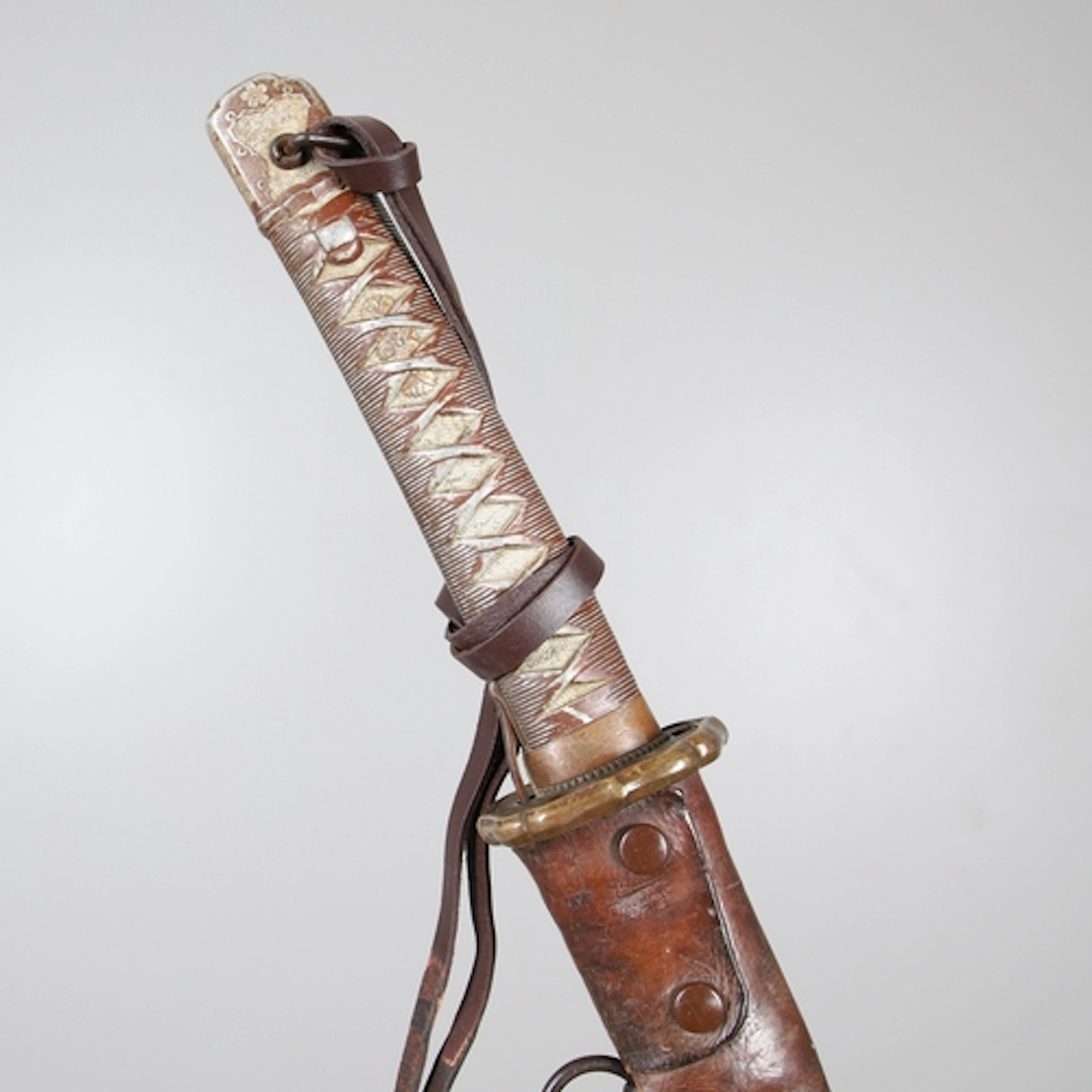A SECOND WORLD WAR JAPANESE NCO'S KATANA AND SCABBARD. The 7...