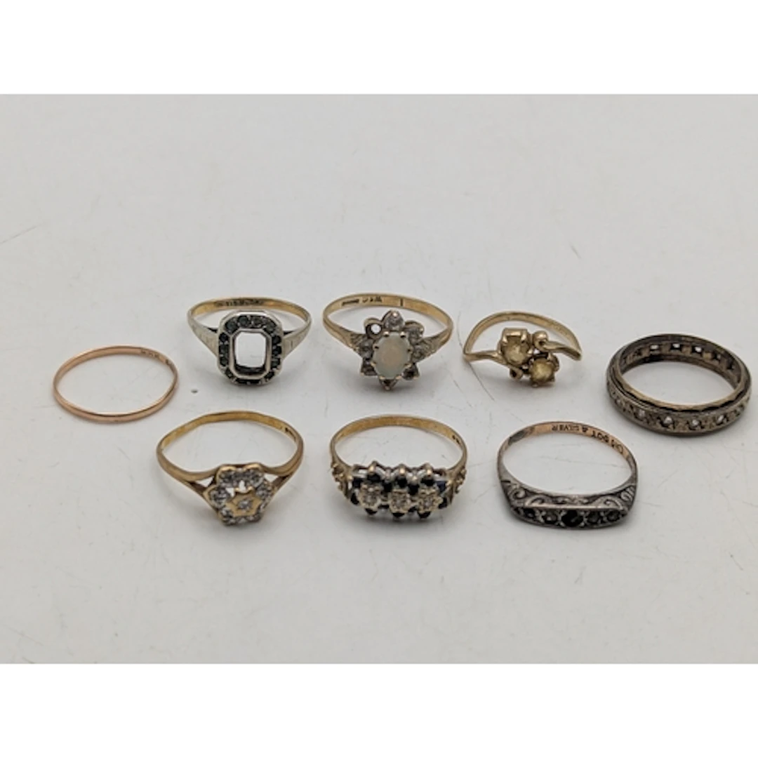 A group of eight 9ct gold rings to include a small gold band...