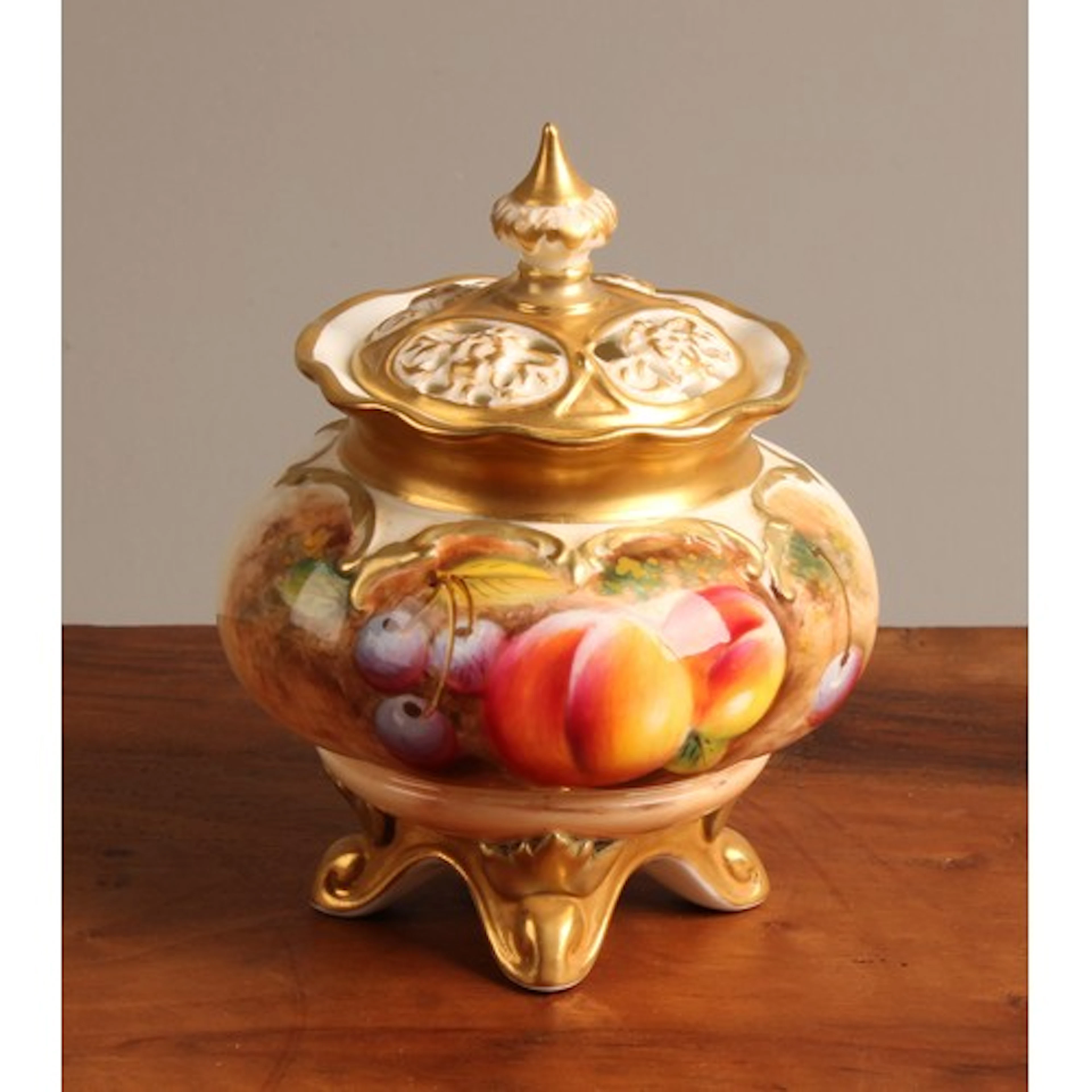 A Royal Worcester lobed ovoid pot pourri vase and cover, pai...