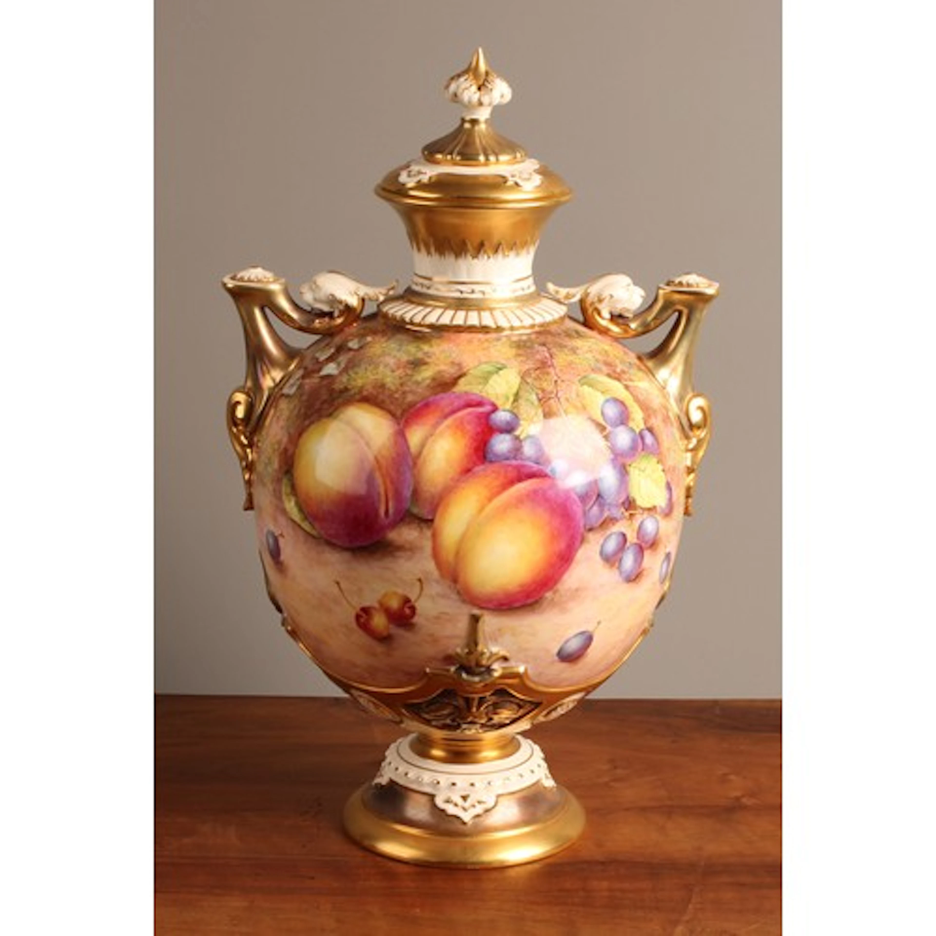 A Royal Worcester ovoid two-handled pedestal vase and cover,...