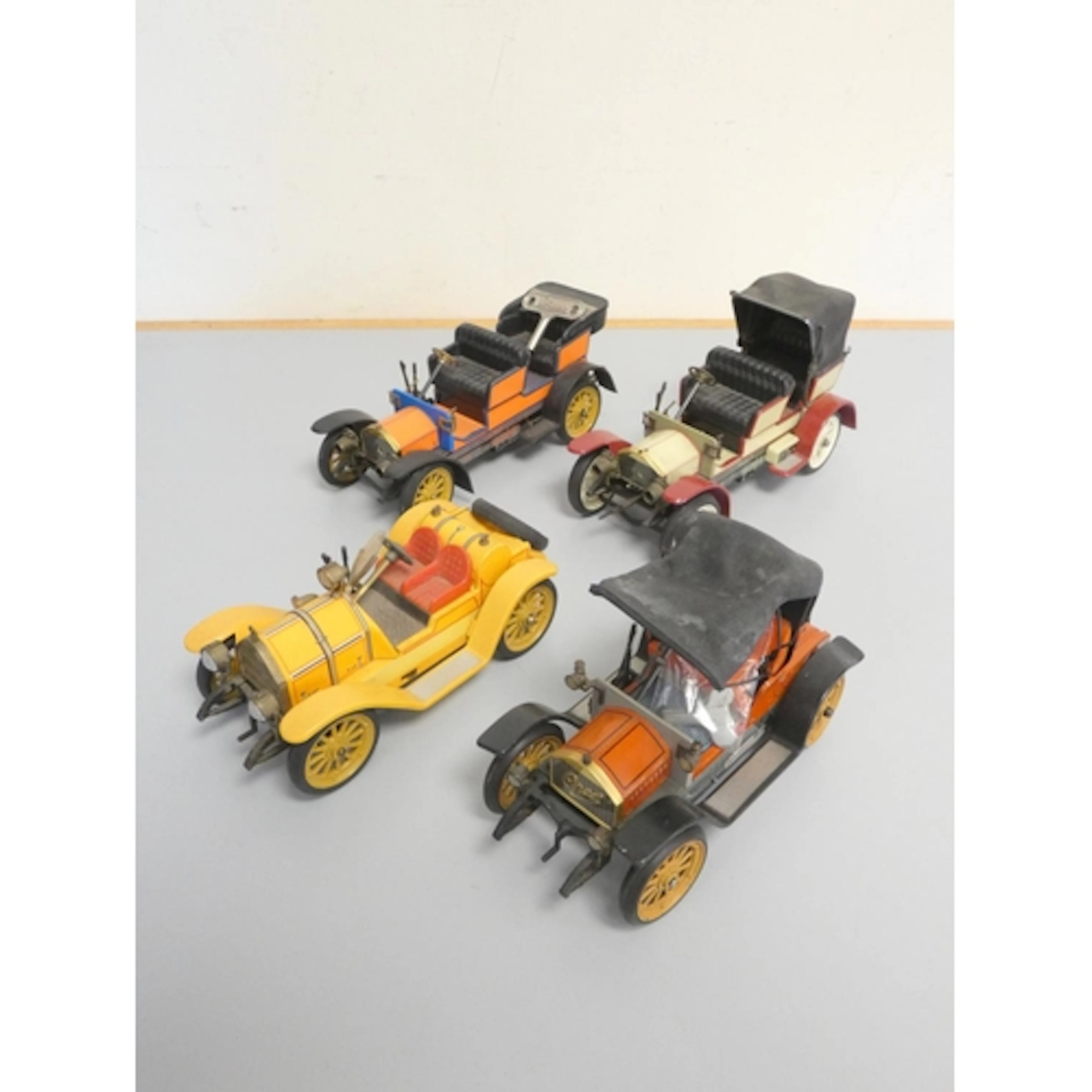 Schuco. Group of four vintage tinplate clockwork vehicles co...