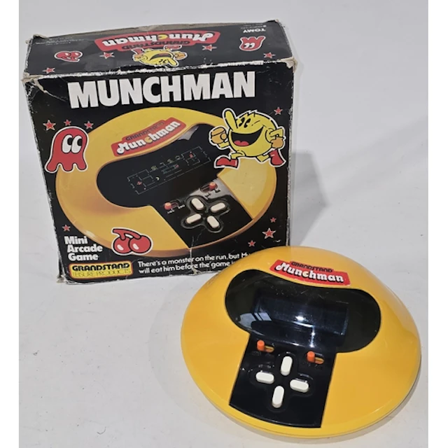 A vintage Grandstand Munchman electronic game c/w original b...