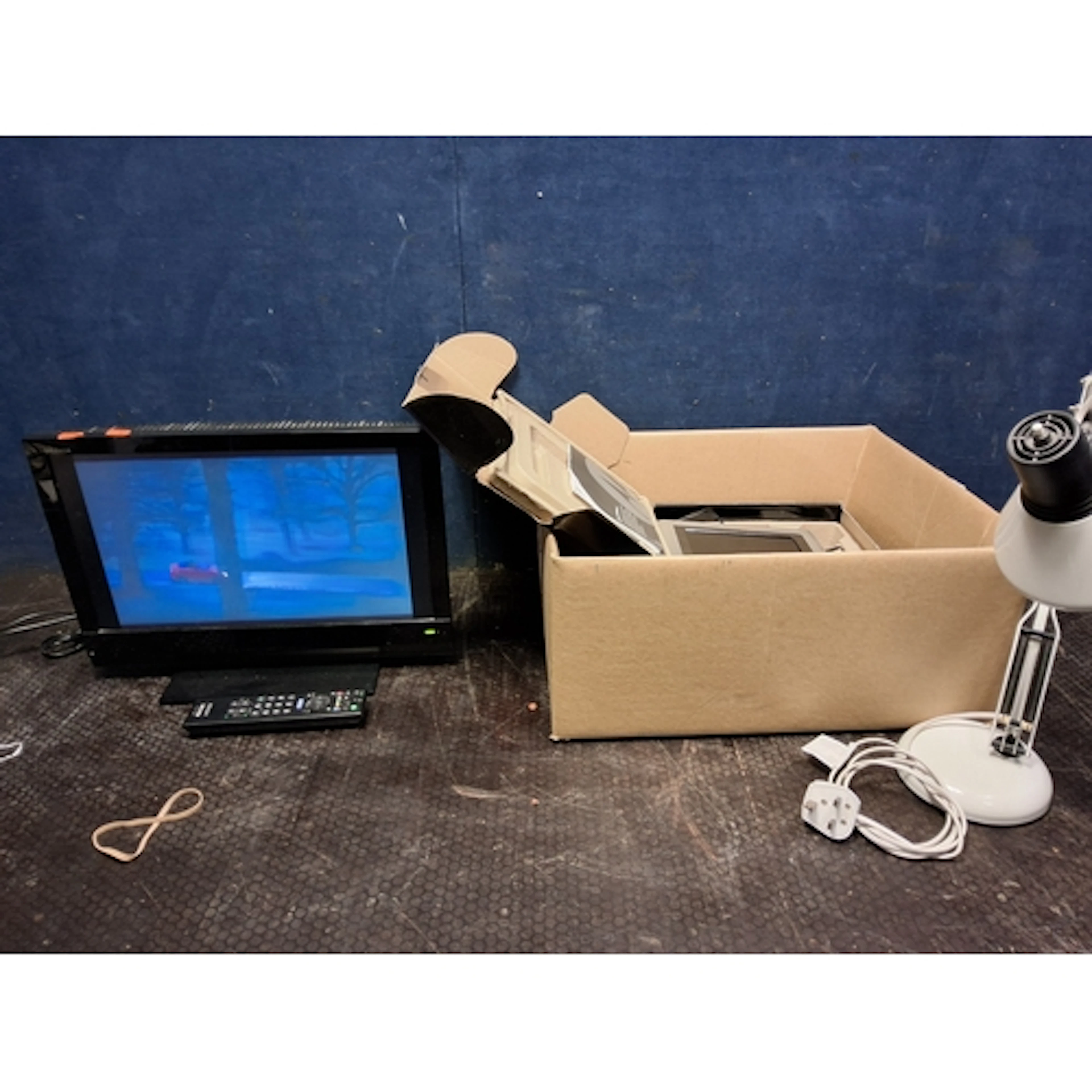 A SONY KDL 19BX200 19in TV with remote, a desk lamp and a Mo...