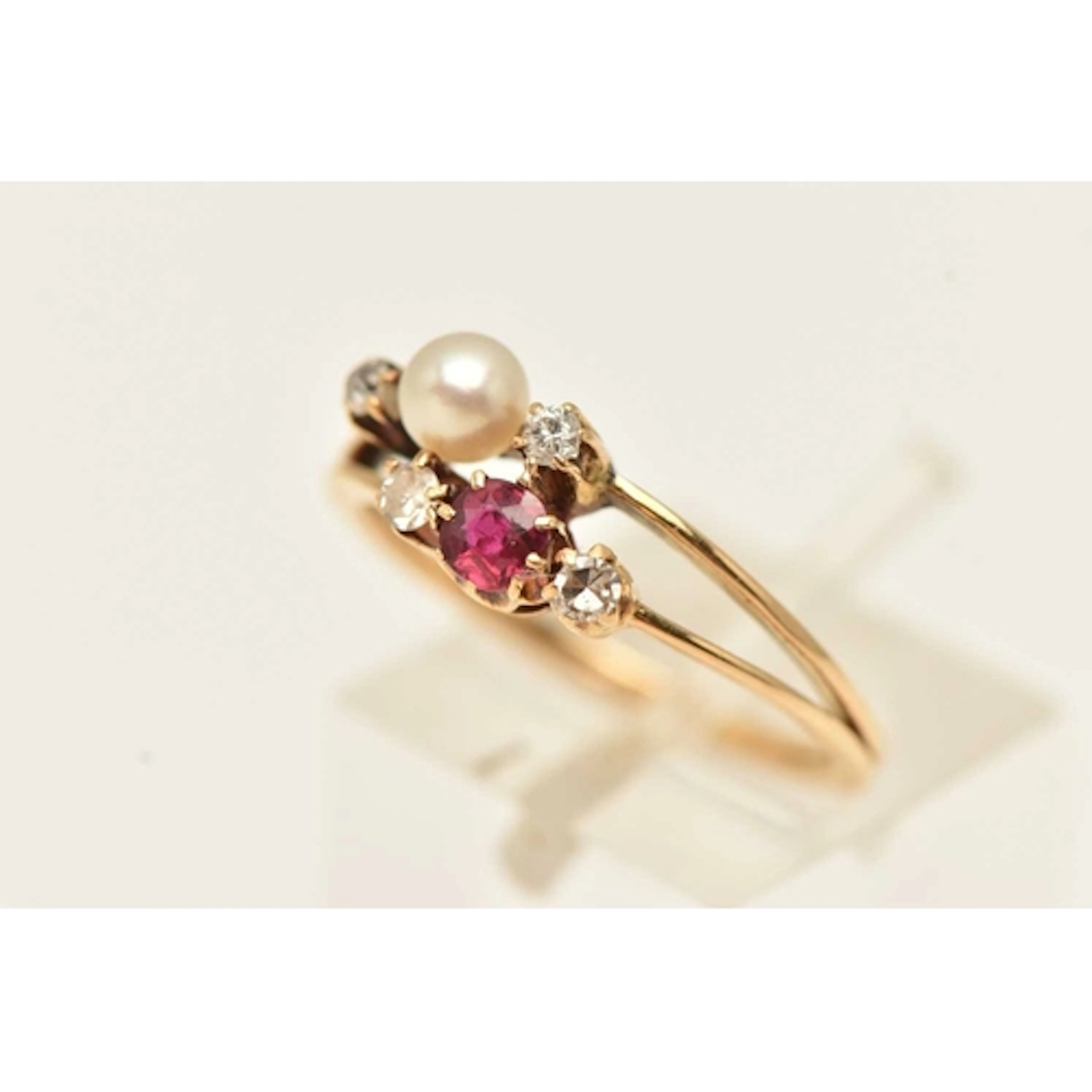A YELLOW METAL DIAMOND, RUBY AND CULTURED PEARL RING, possib...