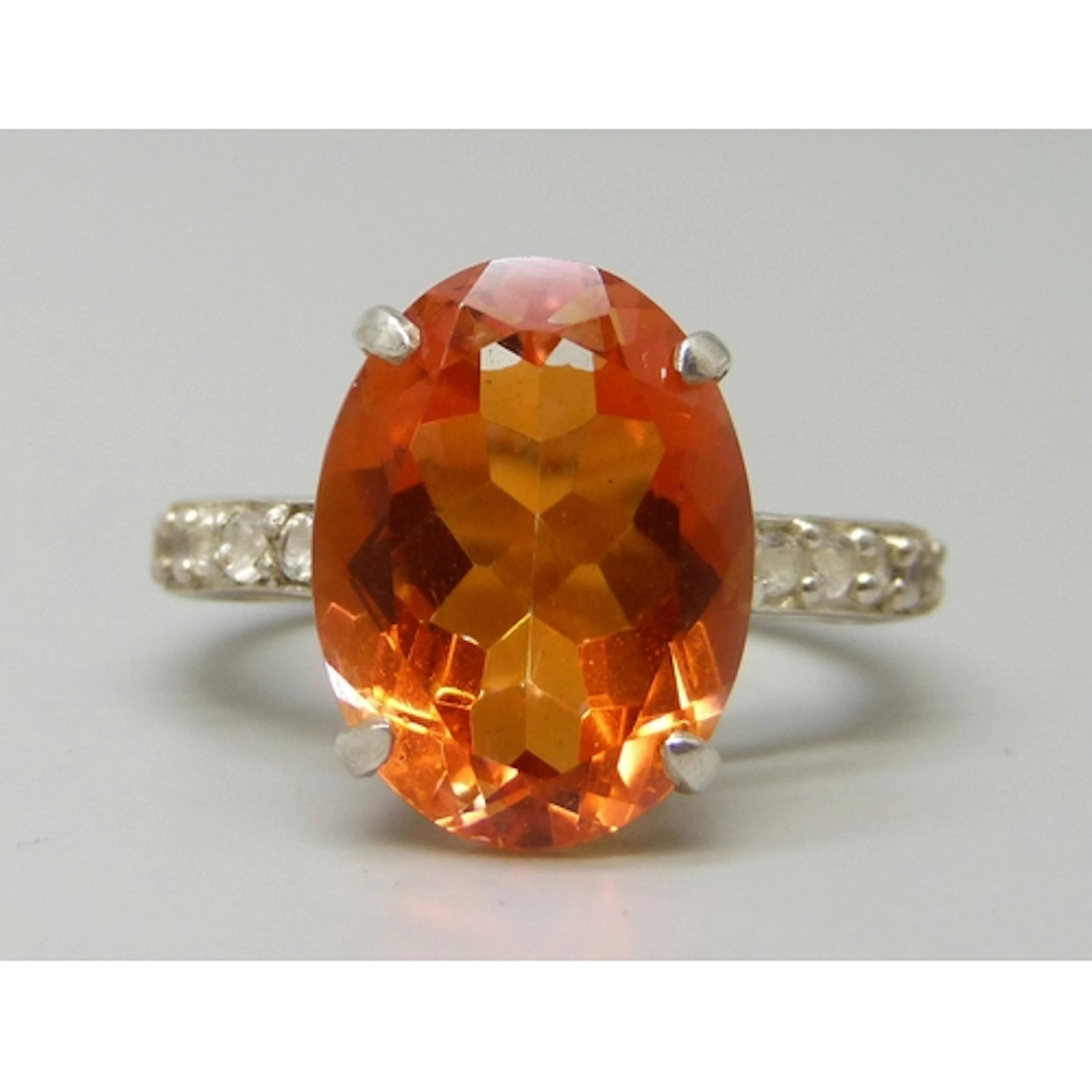 A TGGC silver gilt, fire opal and white stone ring, R.5/S