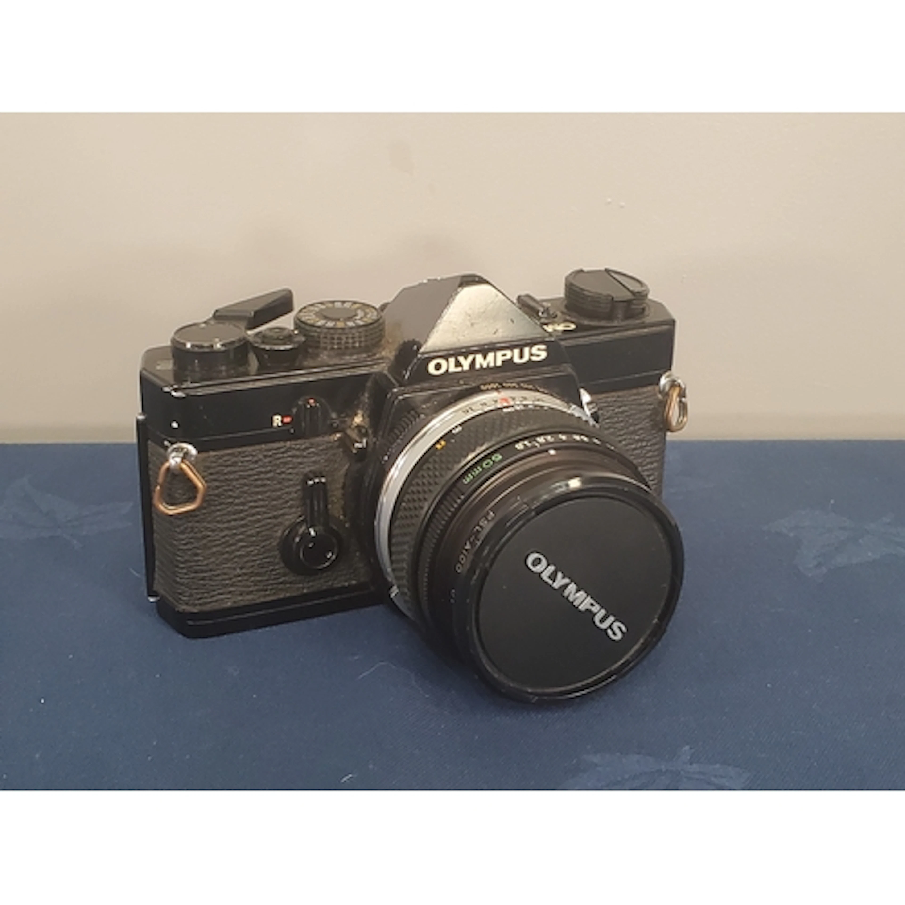 An Olympus OM-1 black with 50mm f1.8 Zuiko