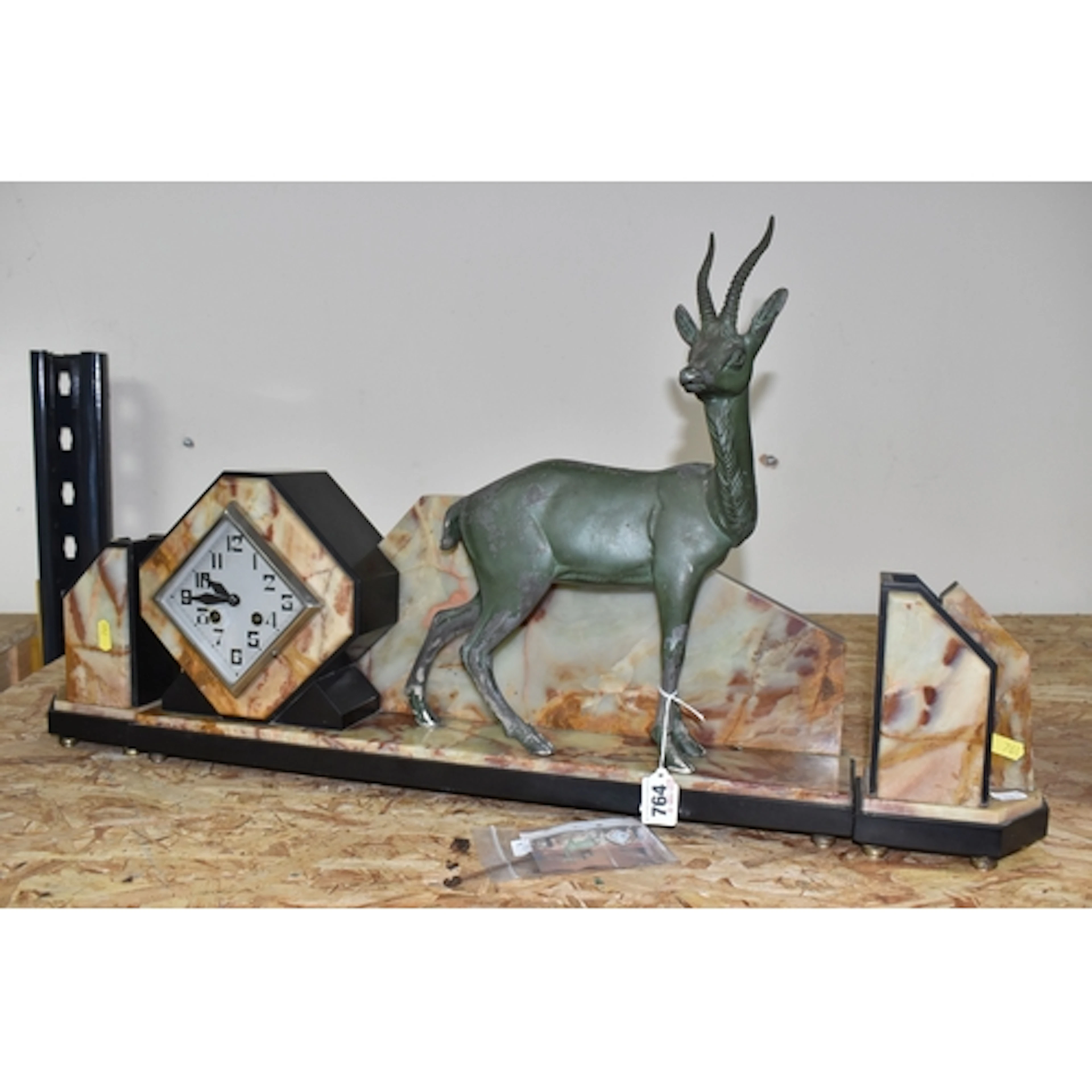 A FRENCH ART DECO MARBLE CLOCK GARNITURE surmounted by a bro...