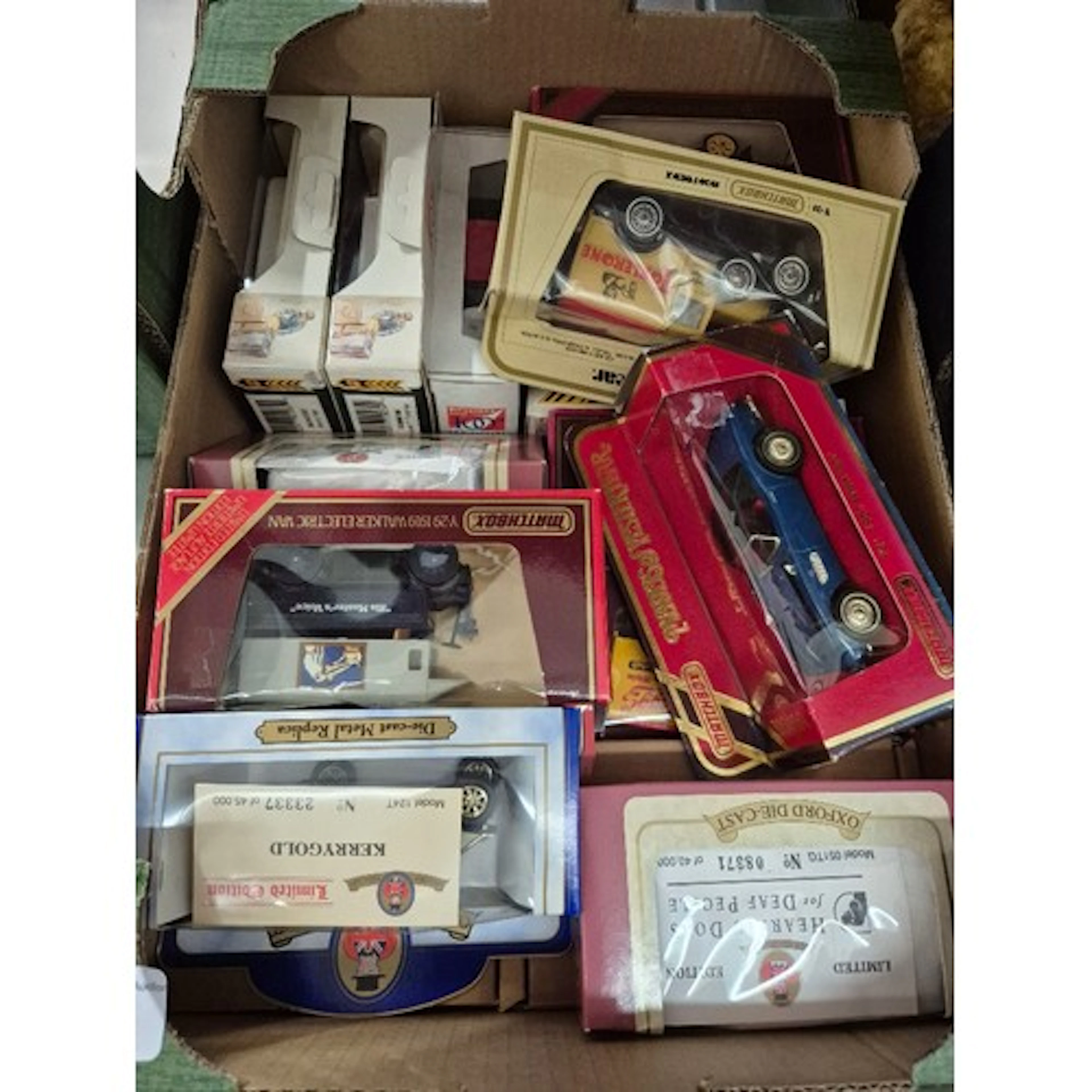 A box of assorted limited edition boxed diecast model cars.