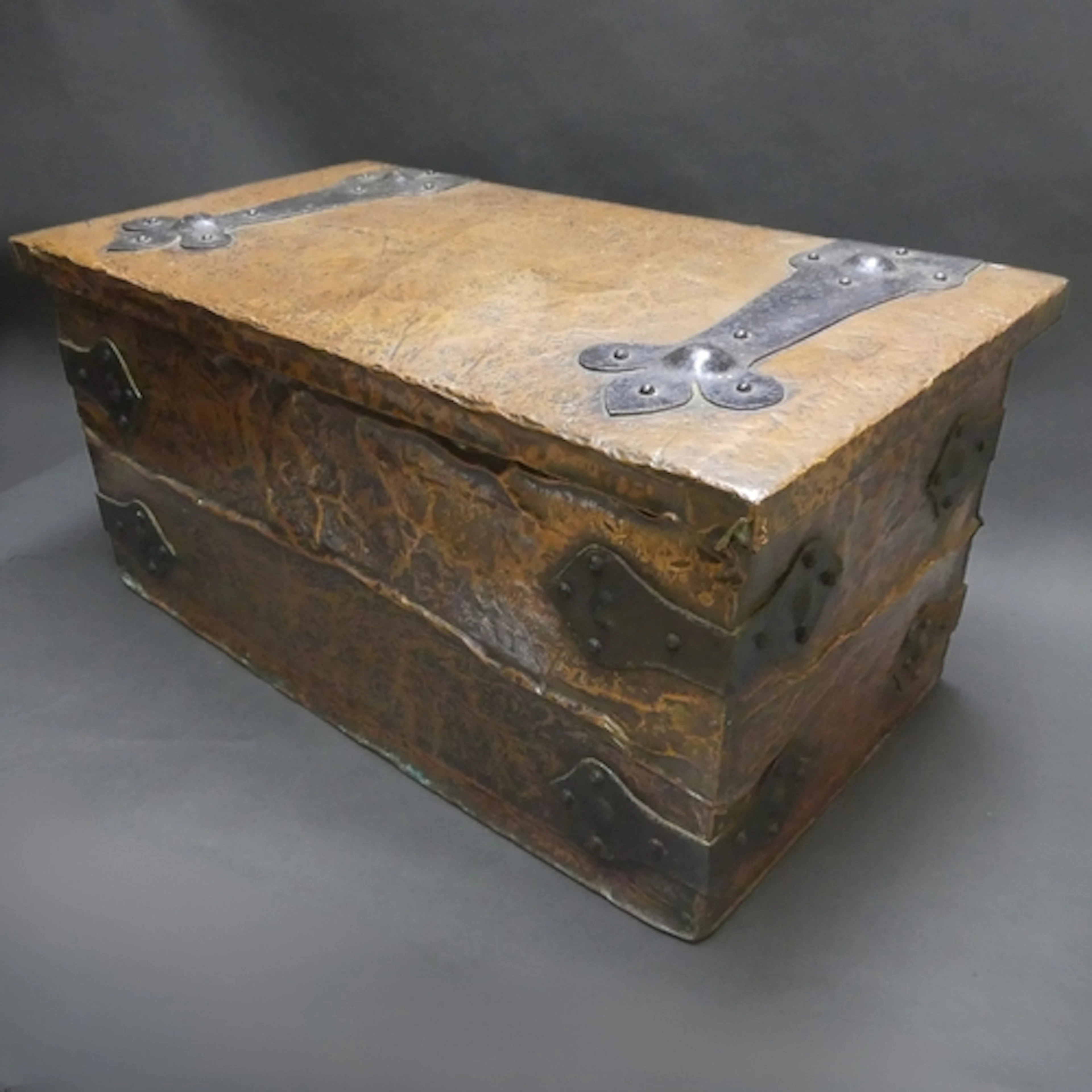 An Arts & Crafts hammered copper clad storage box with decor...