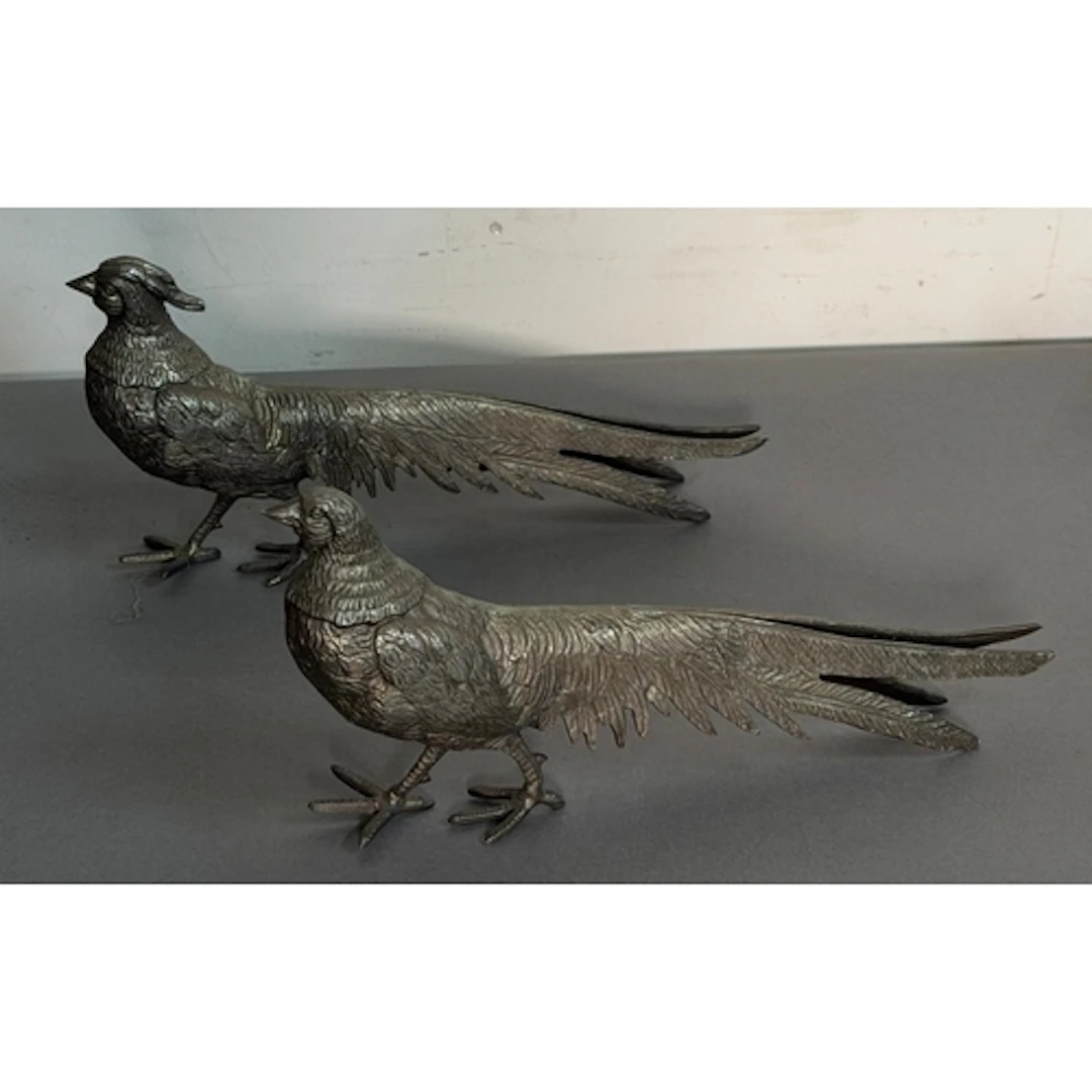 Two white metal ornamental pheasants.