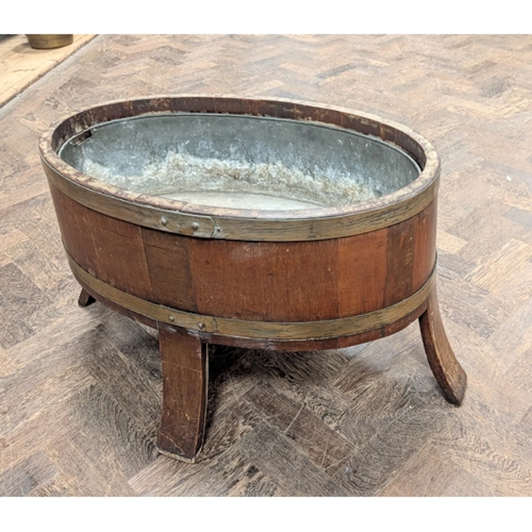 An oval oak and brass bound wine cooler with liner, 26" wide
