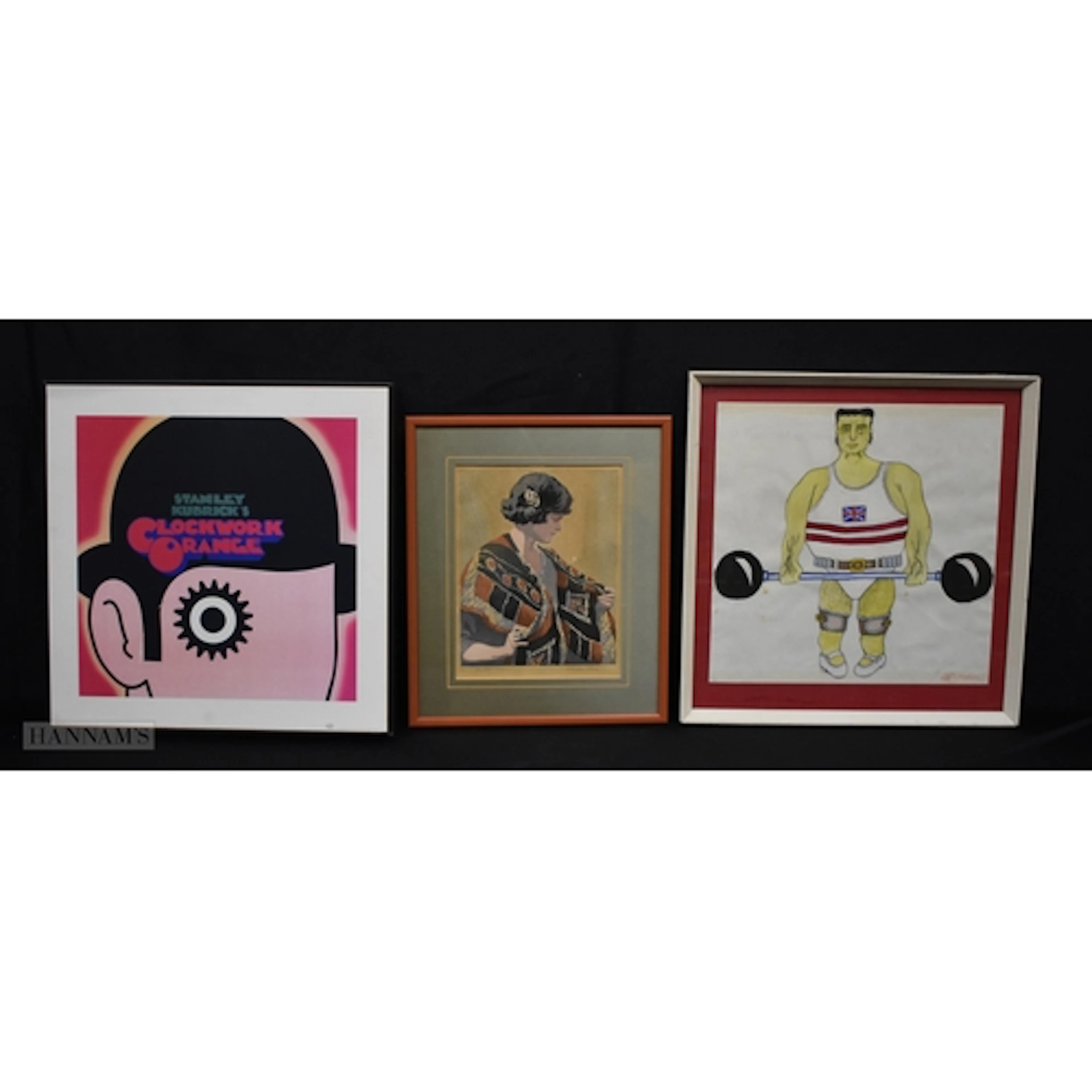 A framed print of a Clockwork orange by Stanley Kubrick toge...