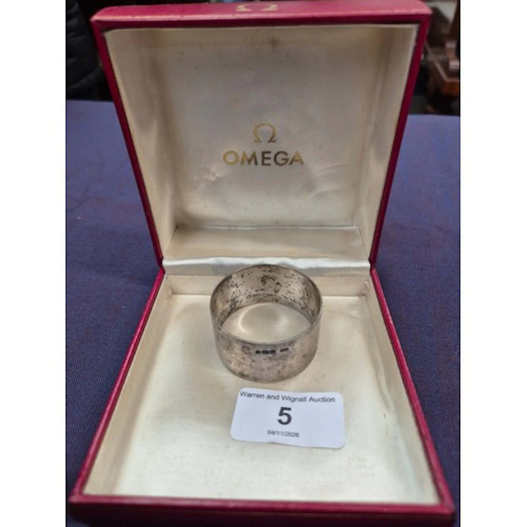 An Omega watch box and a hallmarked silver serviette ring.
